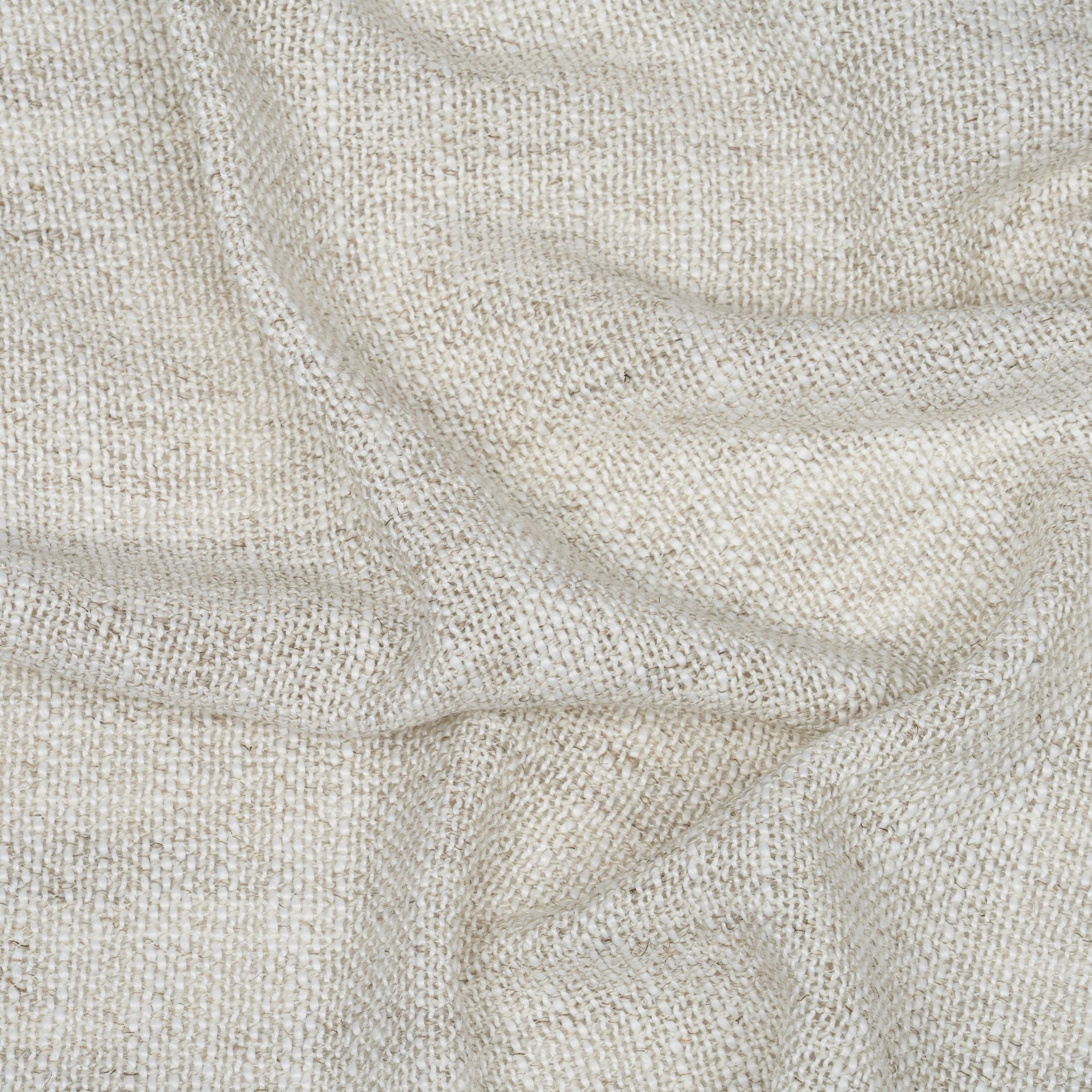 Close-up of beige fabric texture with wavy folds