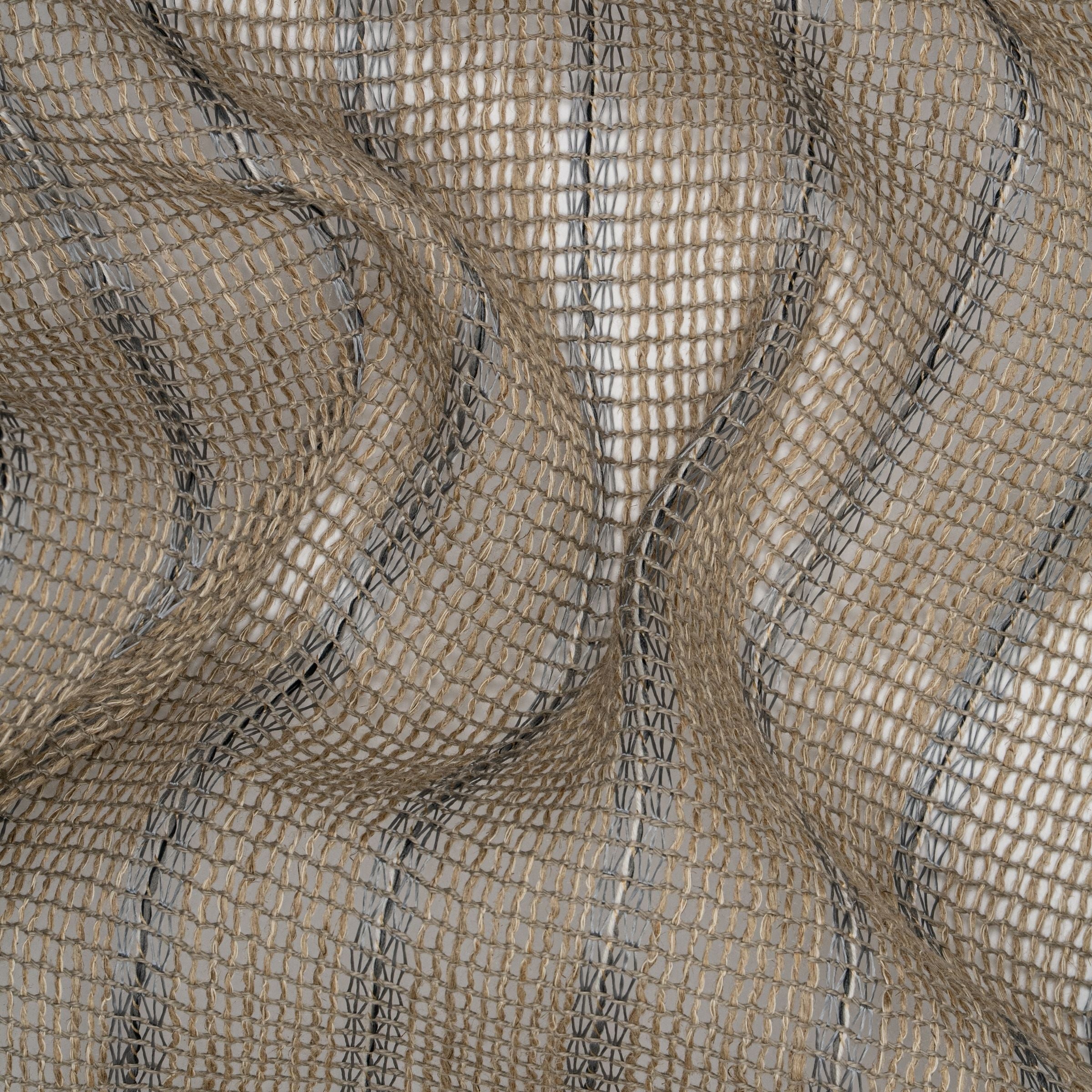 Close-up of loose woven fabric with dark stripes across it