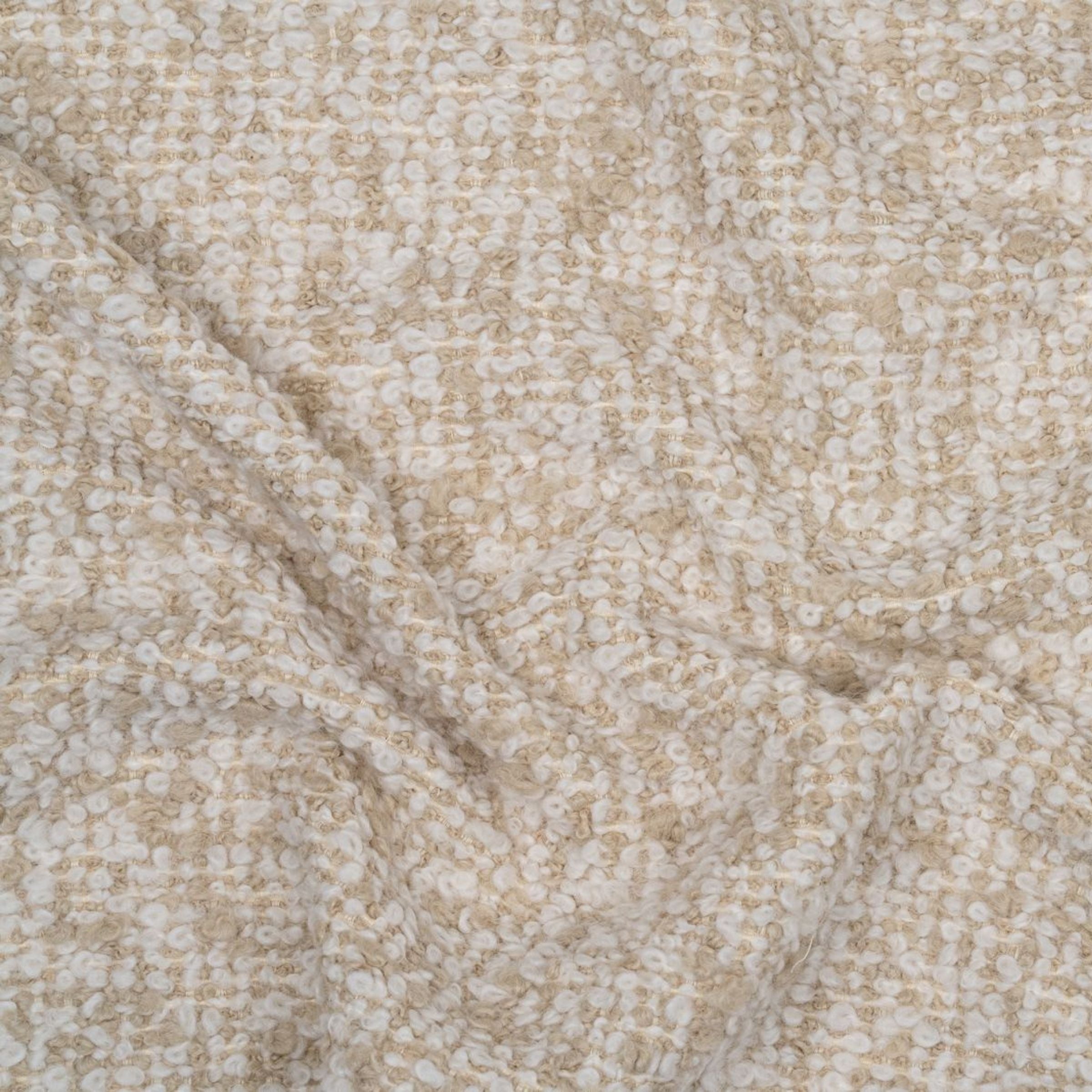 Beige and white boucle textured fabric with subtle folds