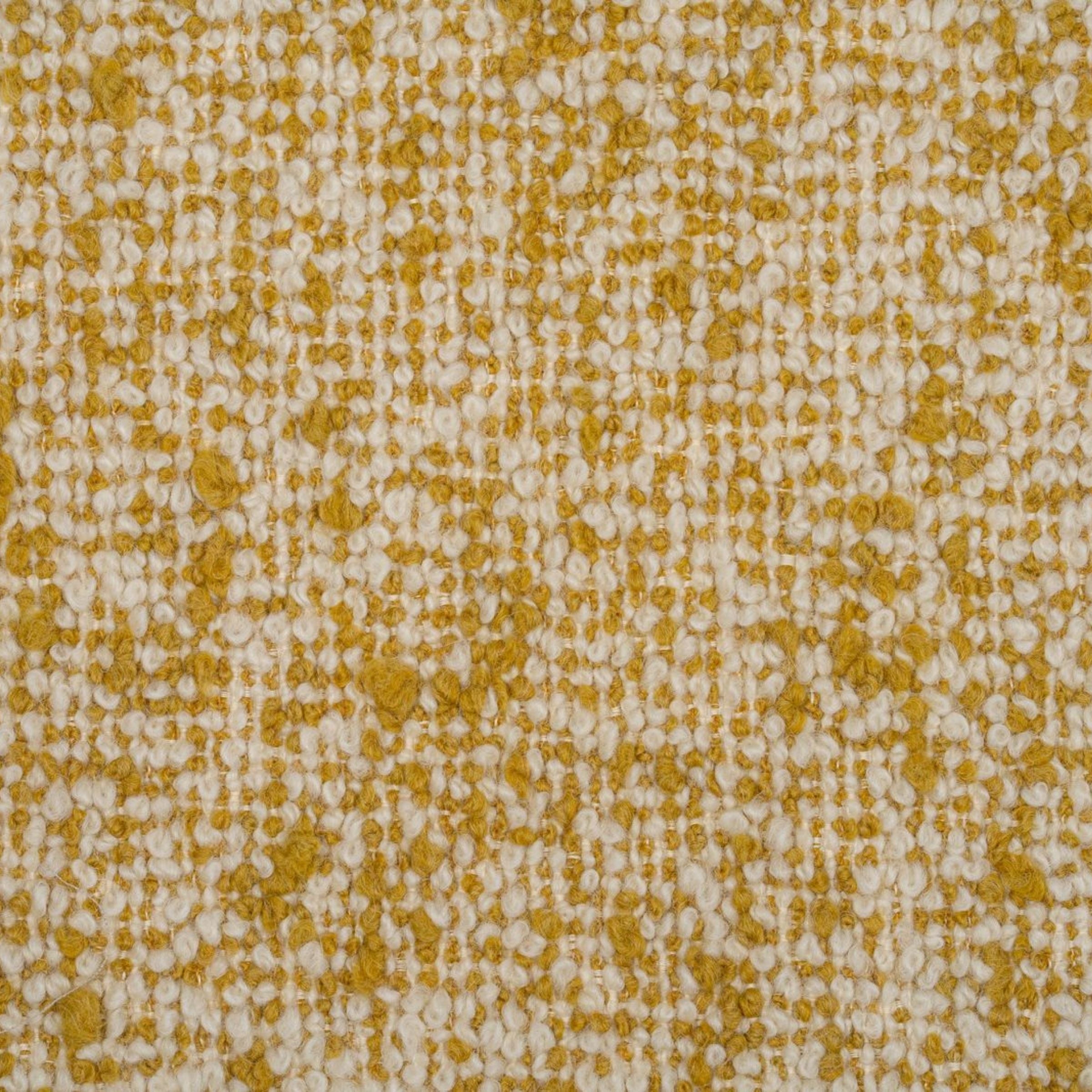 Textured boucle upholstery with a pattern of small yellow and white dots 