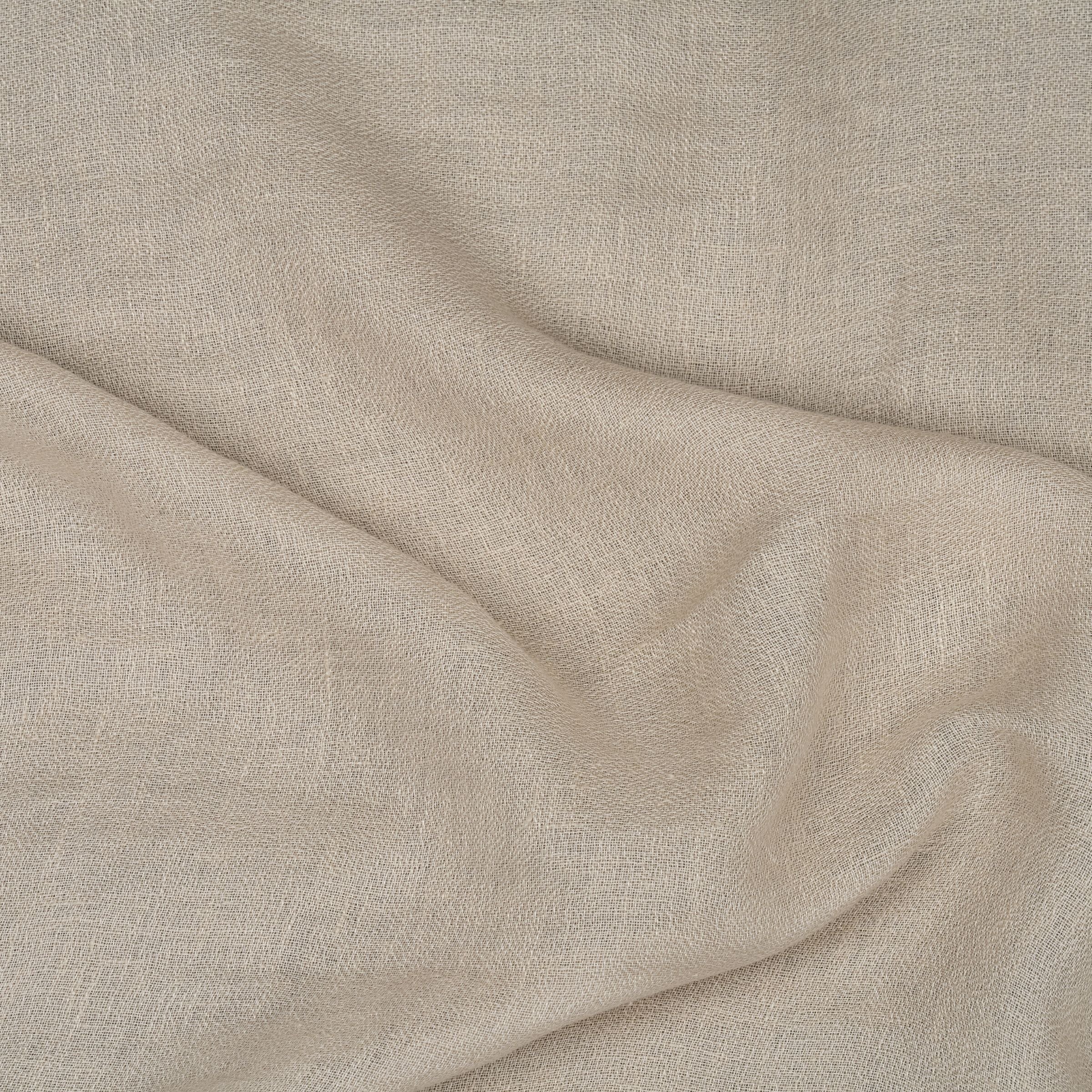 Close-up of beige fabric with visible sheen and subtle folds