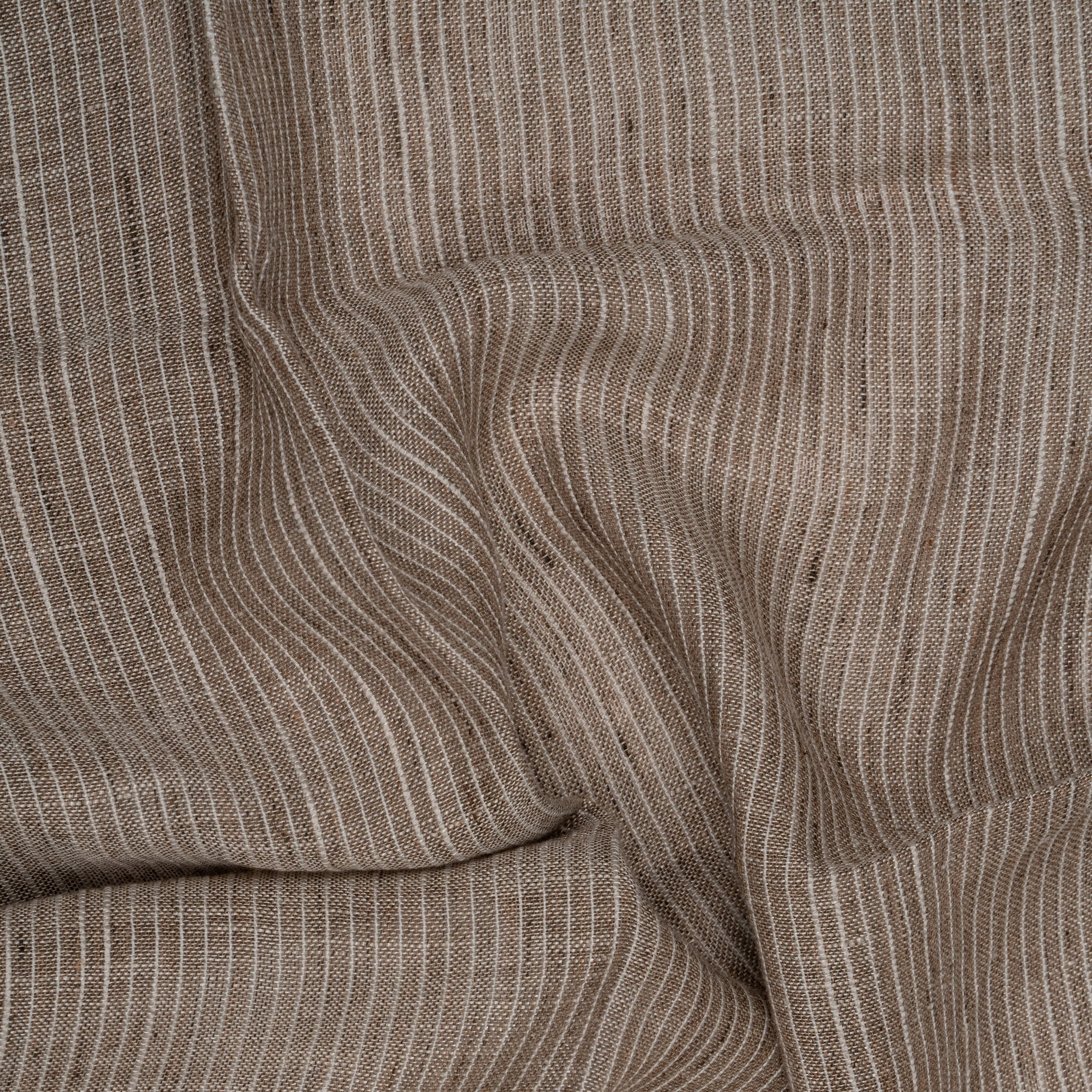 Close-up of brown and white striped fabric with subtle folds