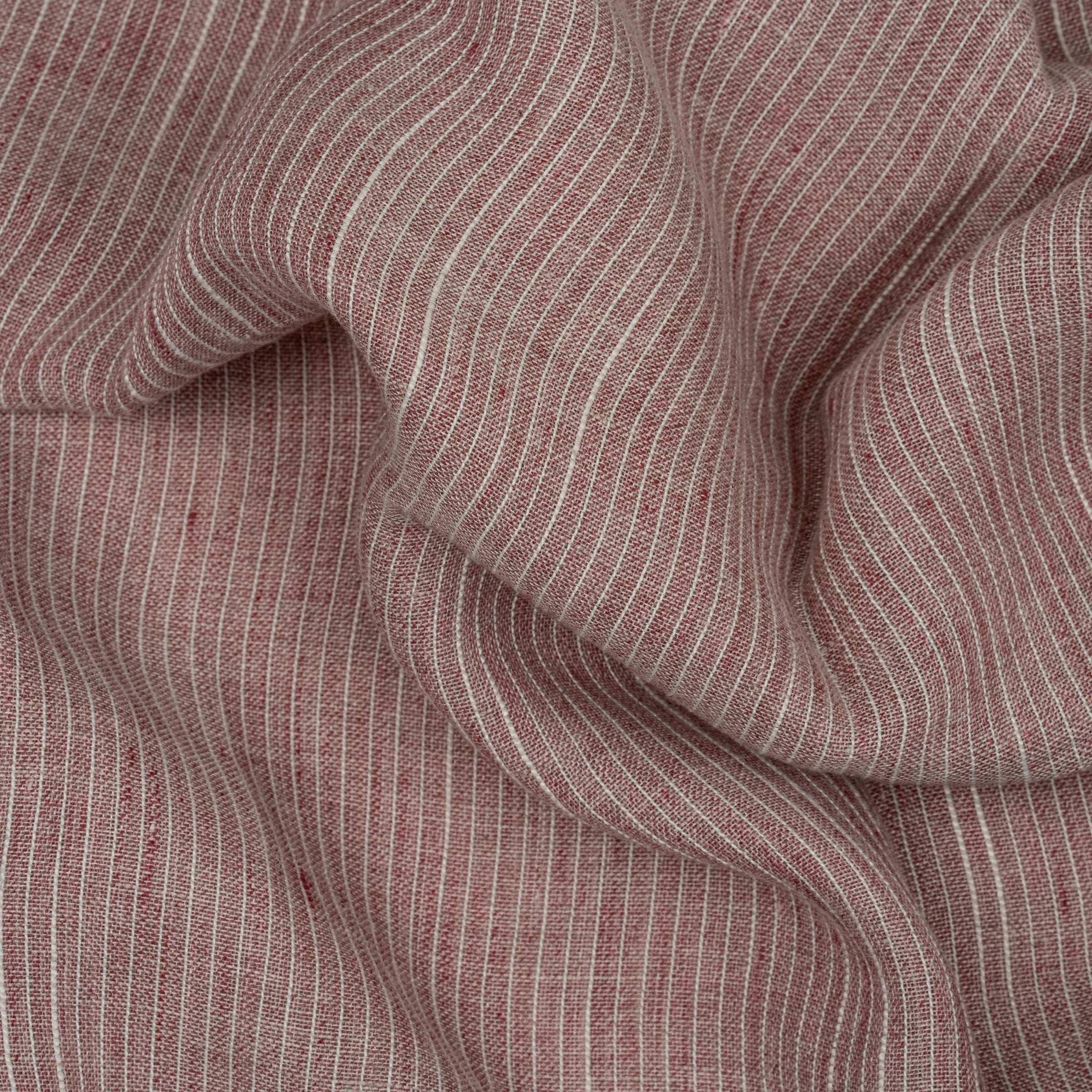 Close-up of red and white striped fabric with wavy folds