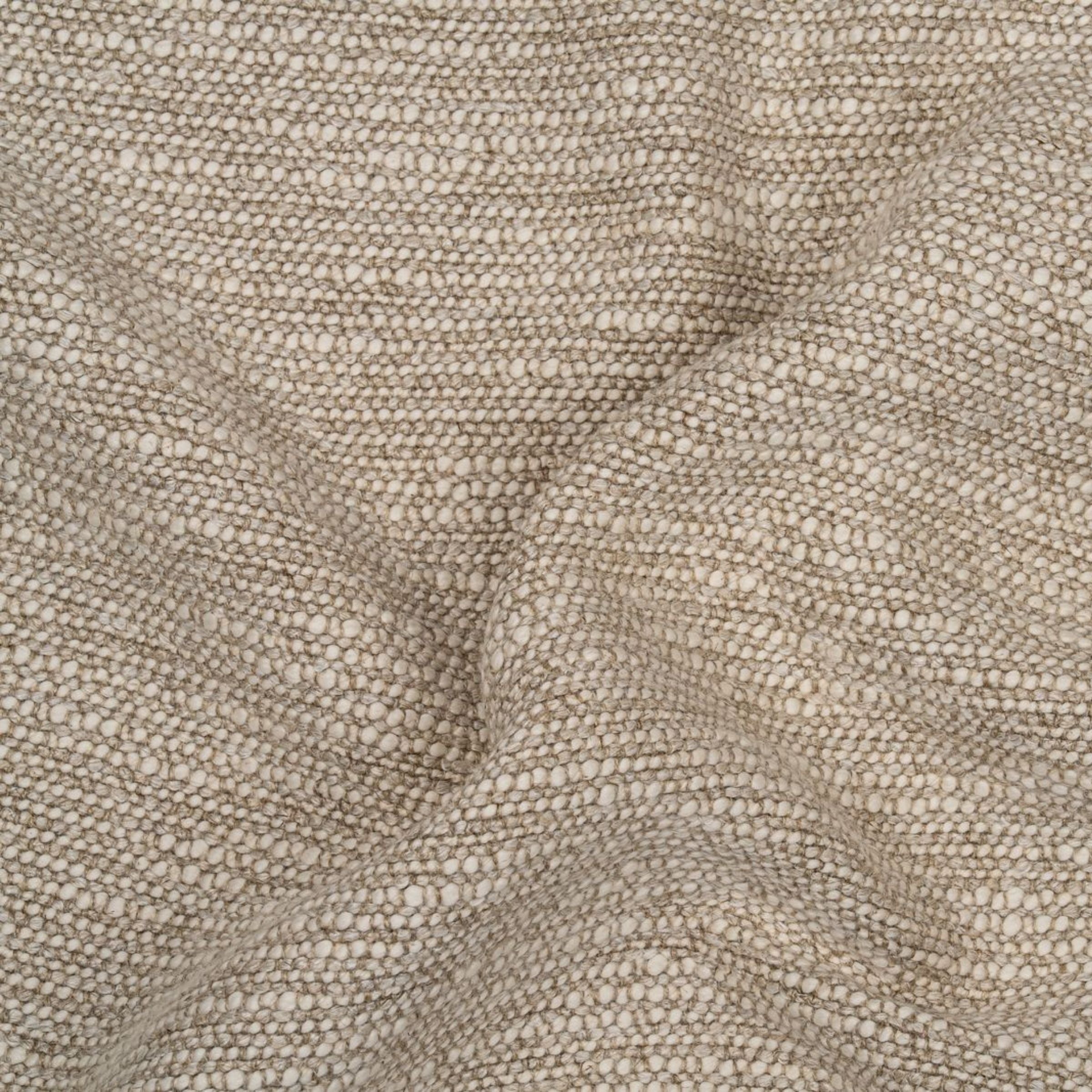 Close-up of textured beige upholstery with subtle folds