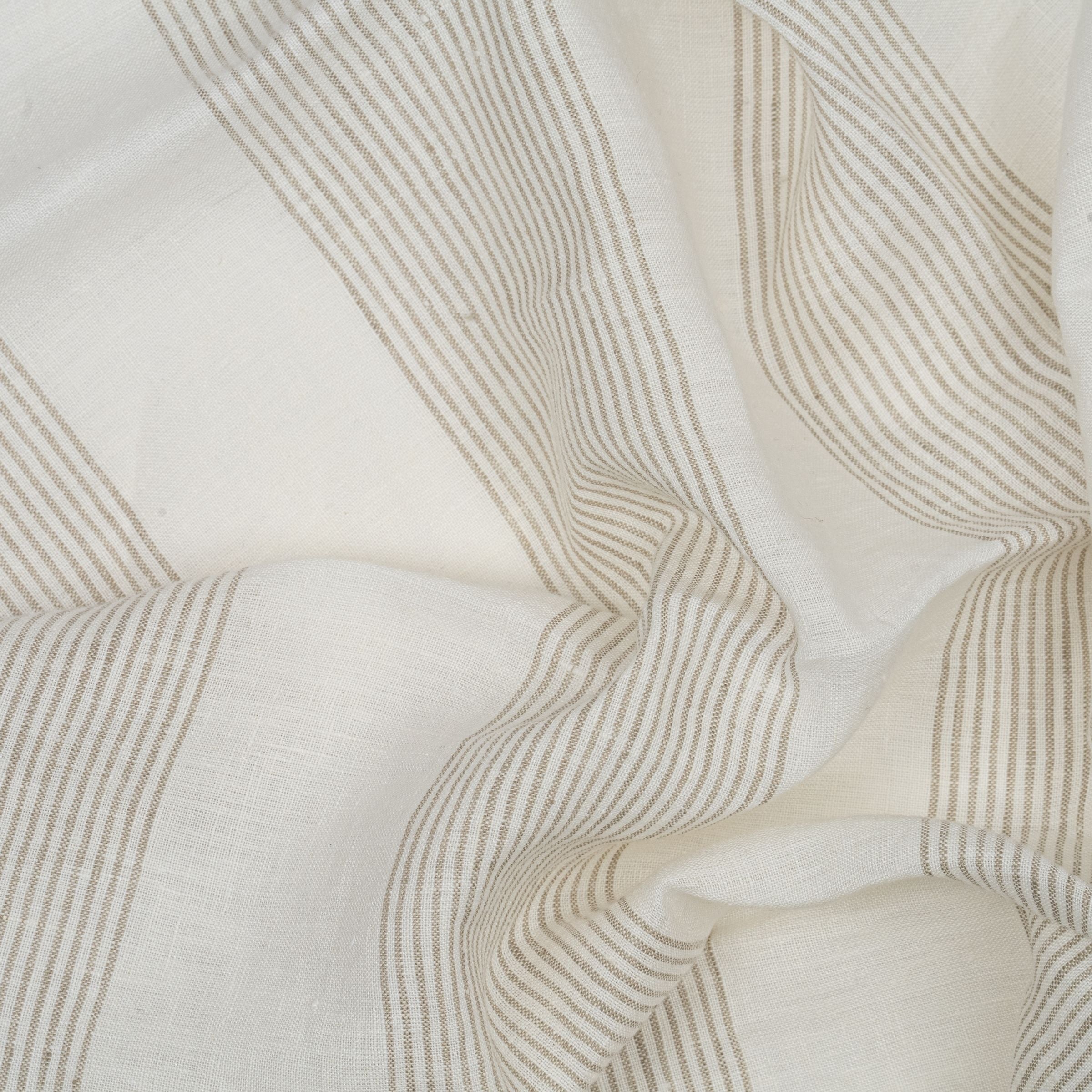 White and light brown striped fabric with wavy fold