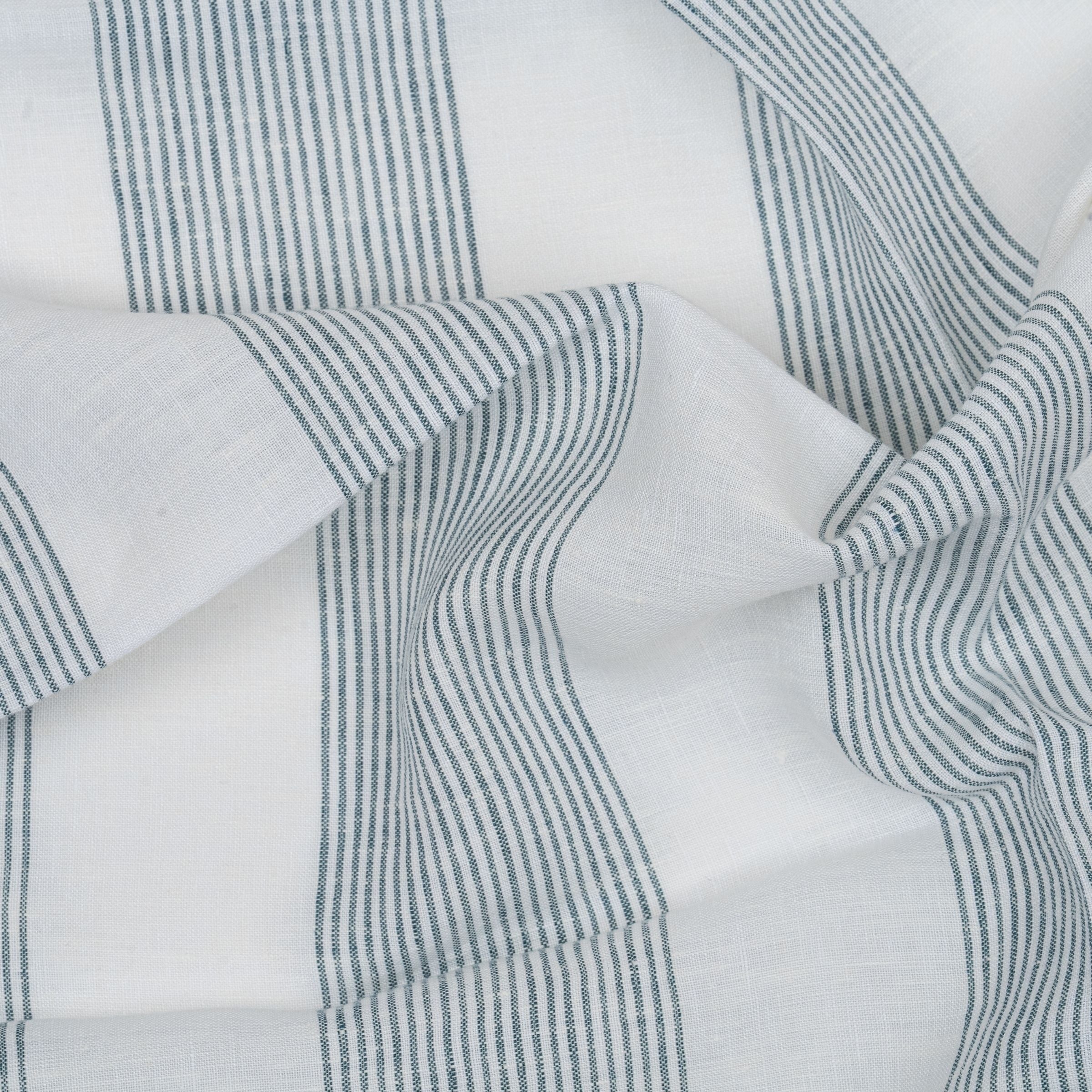 Fabric with blue and white stripes with wavy folds
