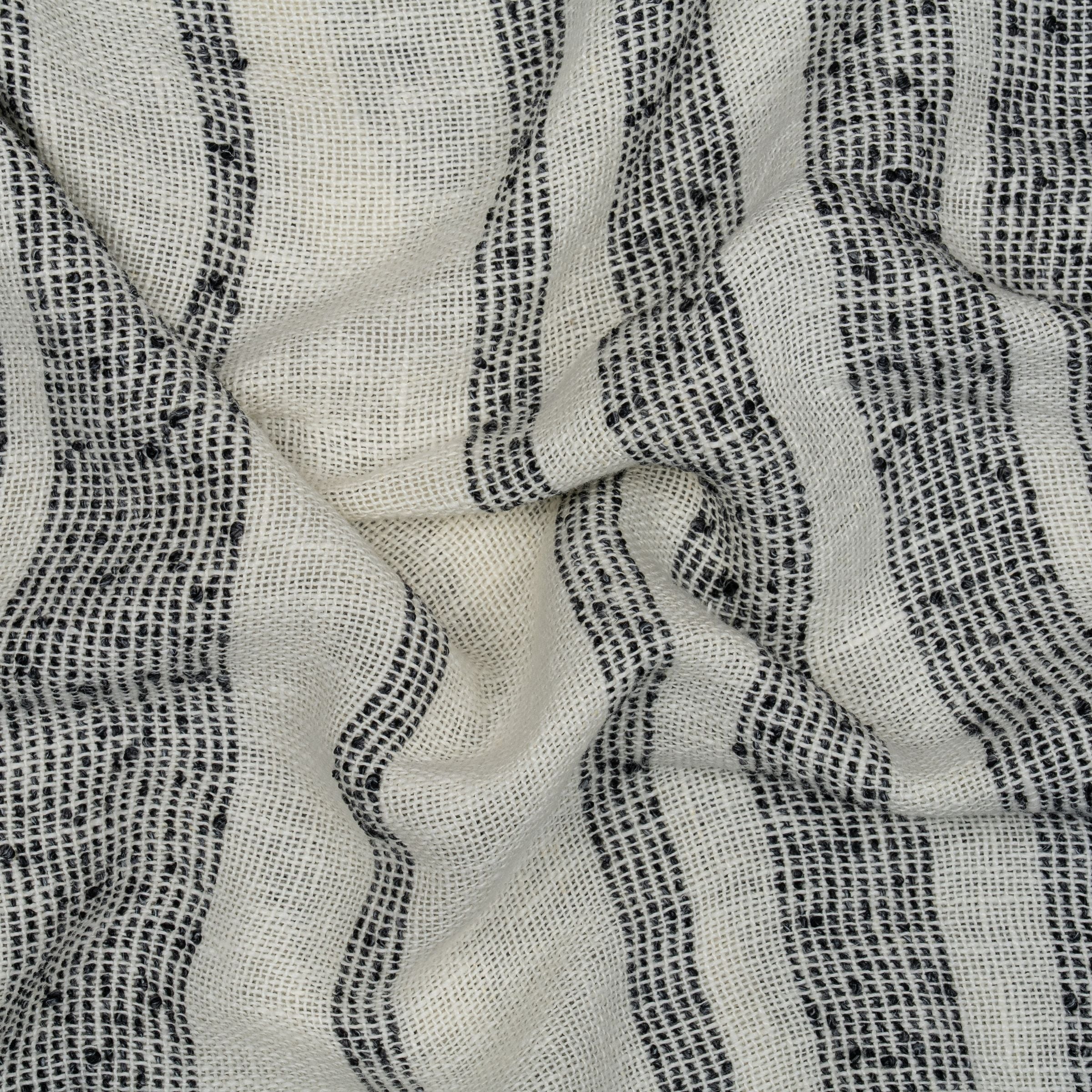 White fabric with black textured stripes and wavy folds