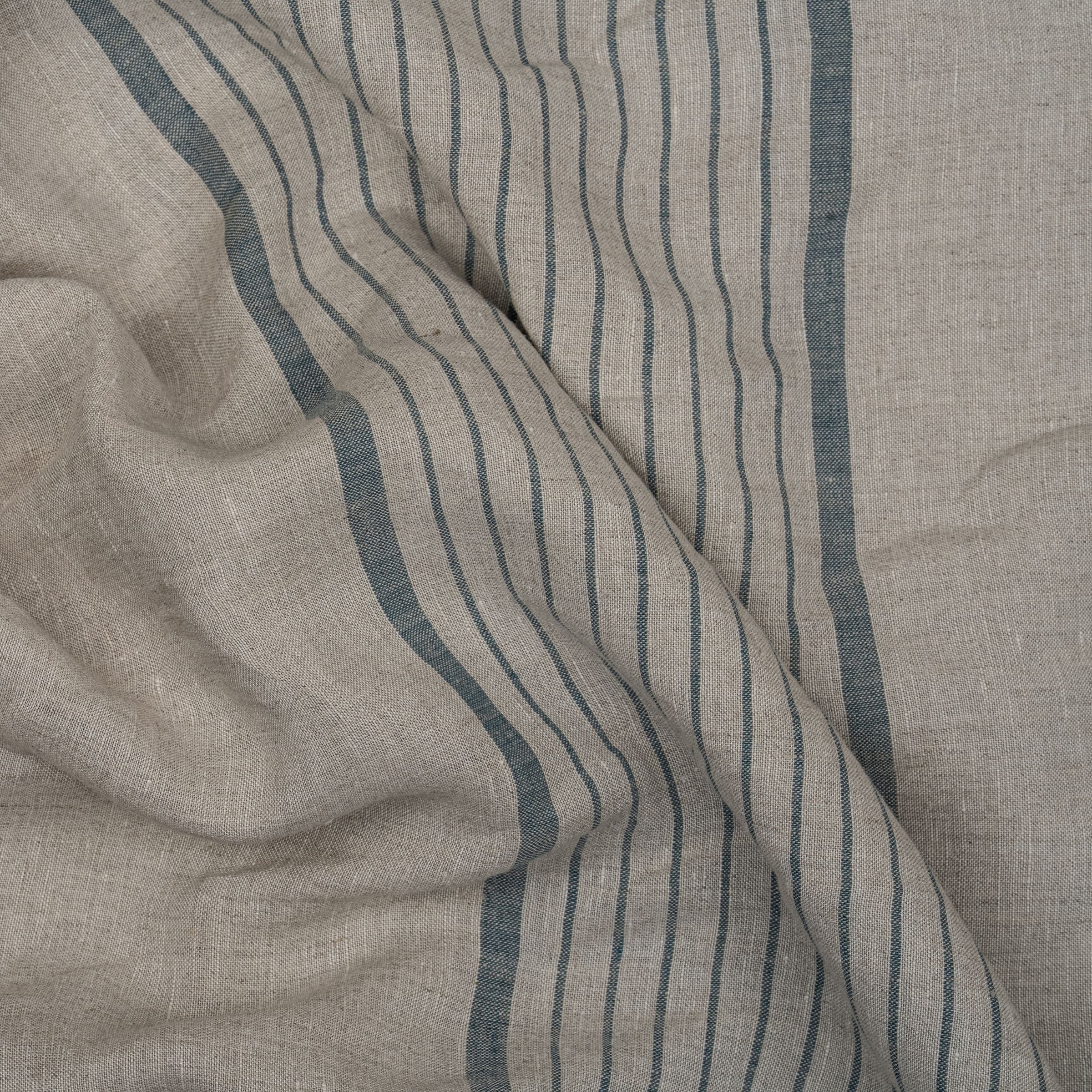 Gray fabric with ocean blue wide and thin stripes, and wavy folds