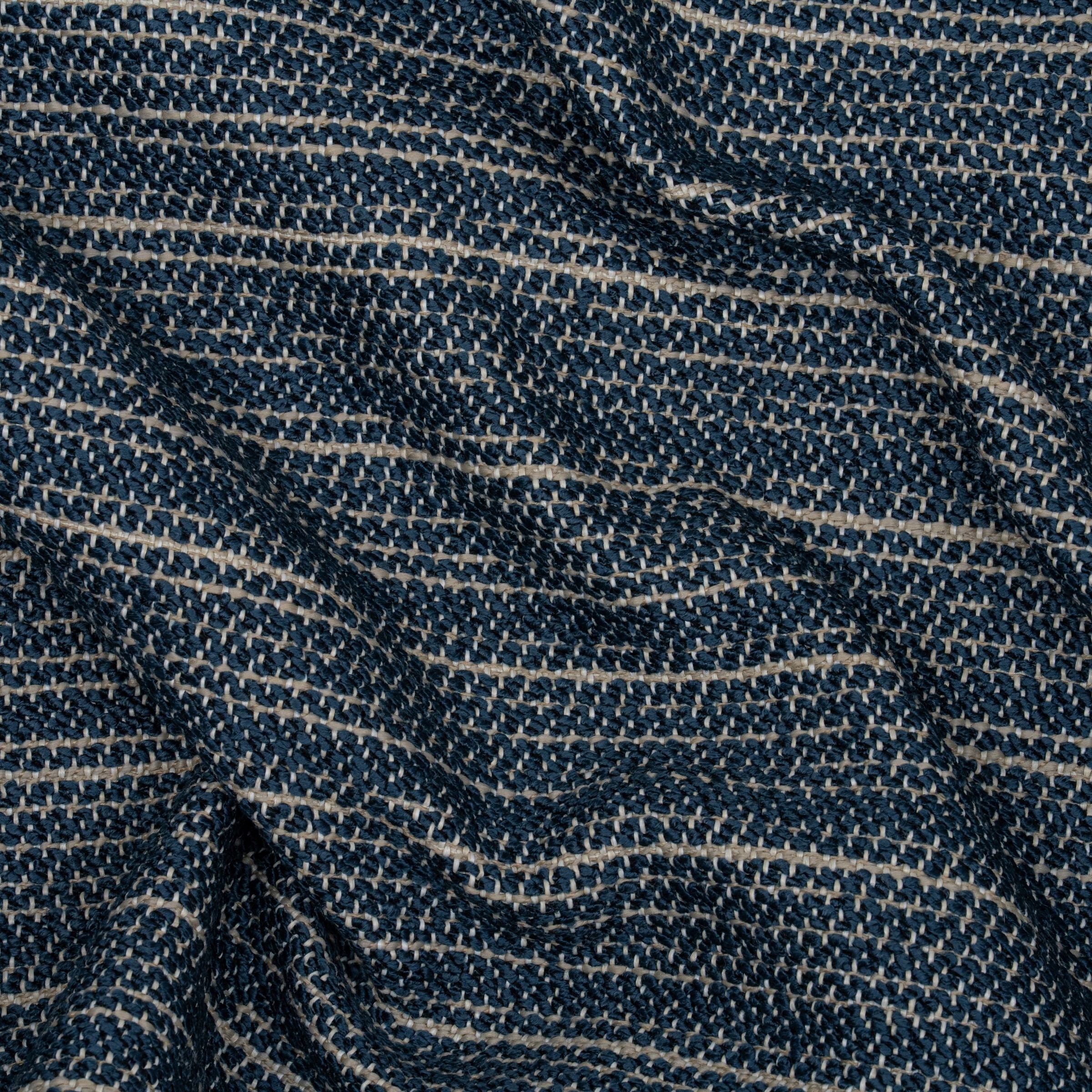 Close-up of a textured blue and beige upholstery pattern with wavy folds