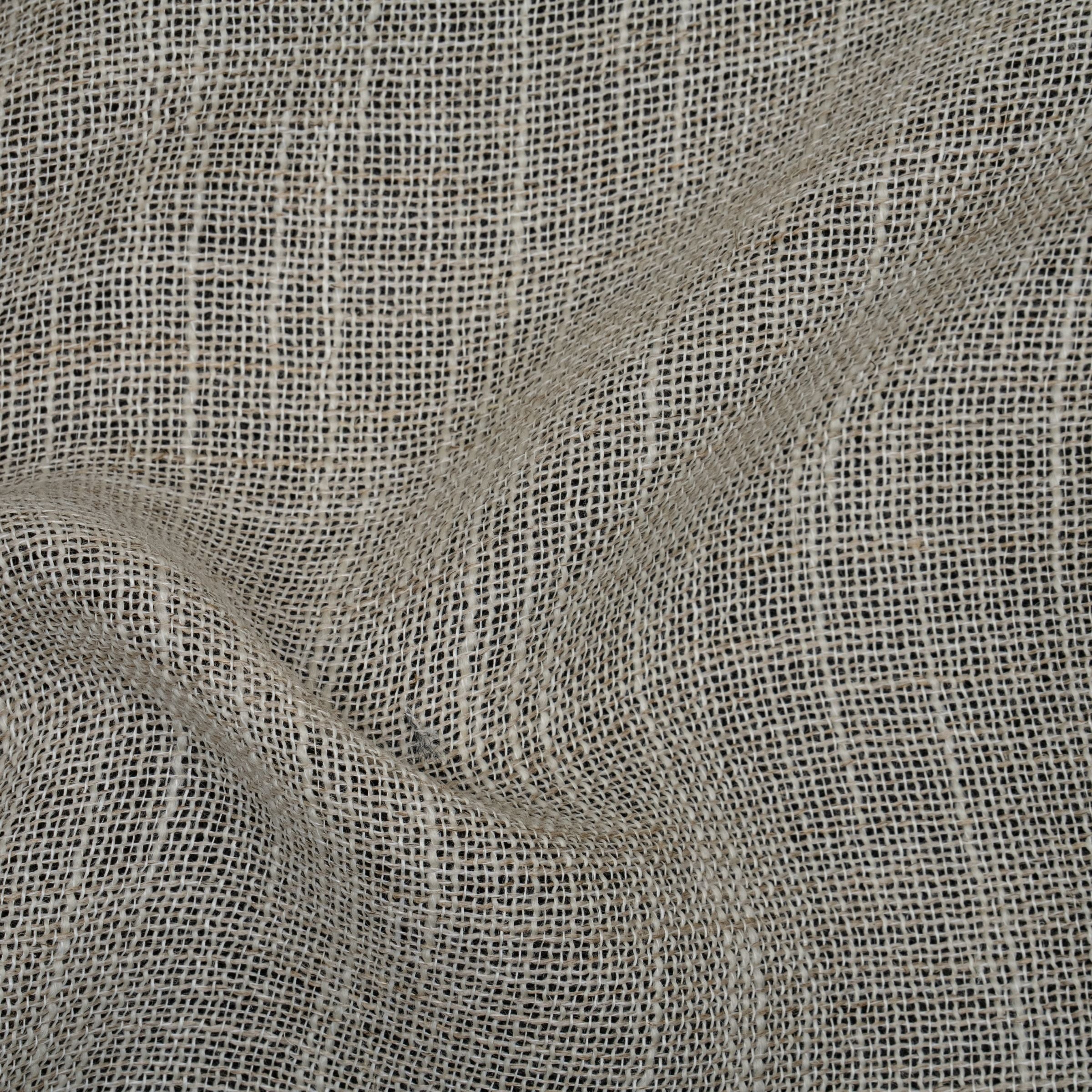 Close-up of textured beige fabric with subtle folds