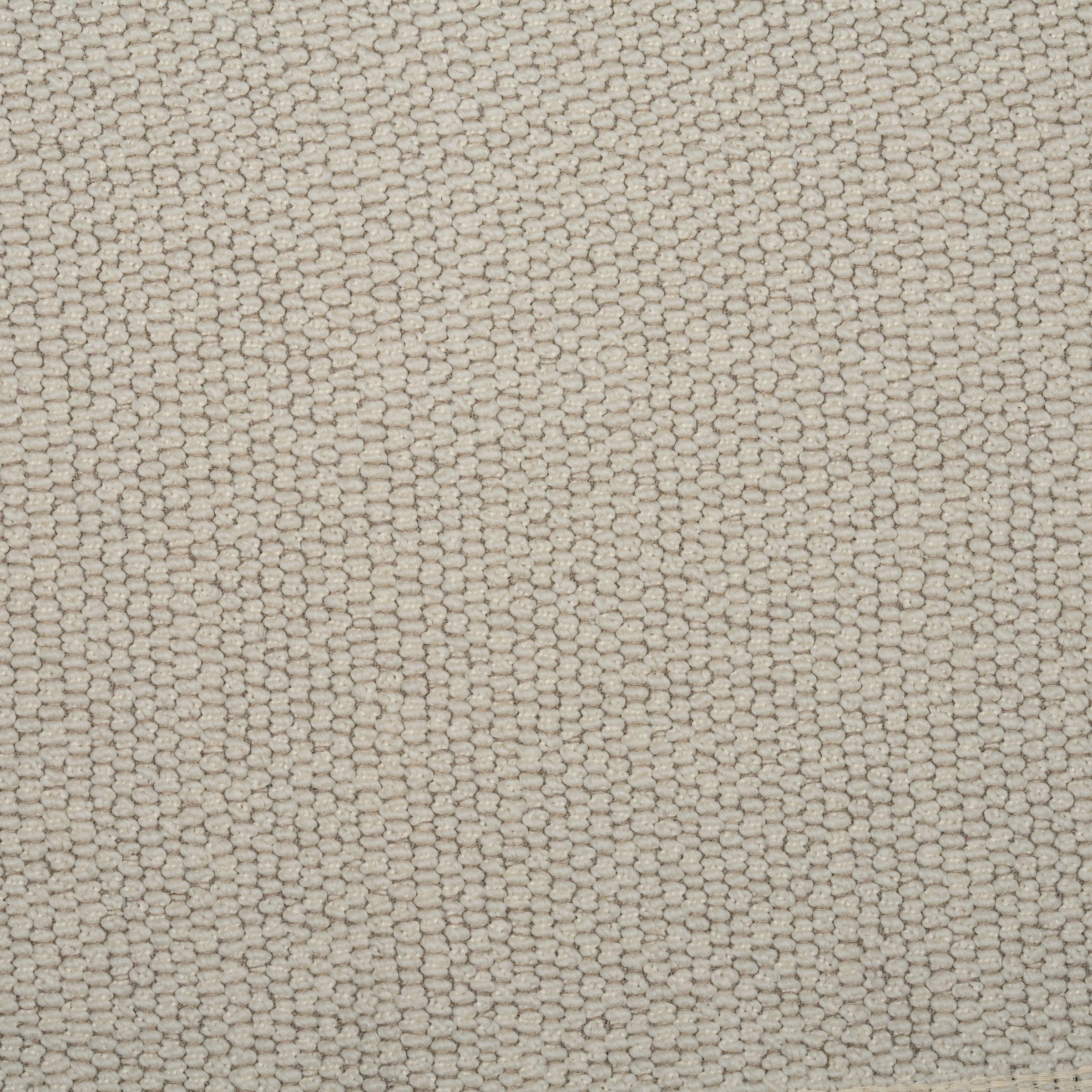 Zoomed out view of a cream color textured upholstery