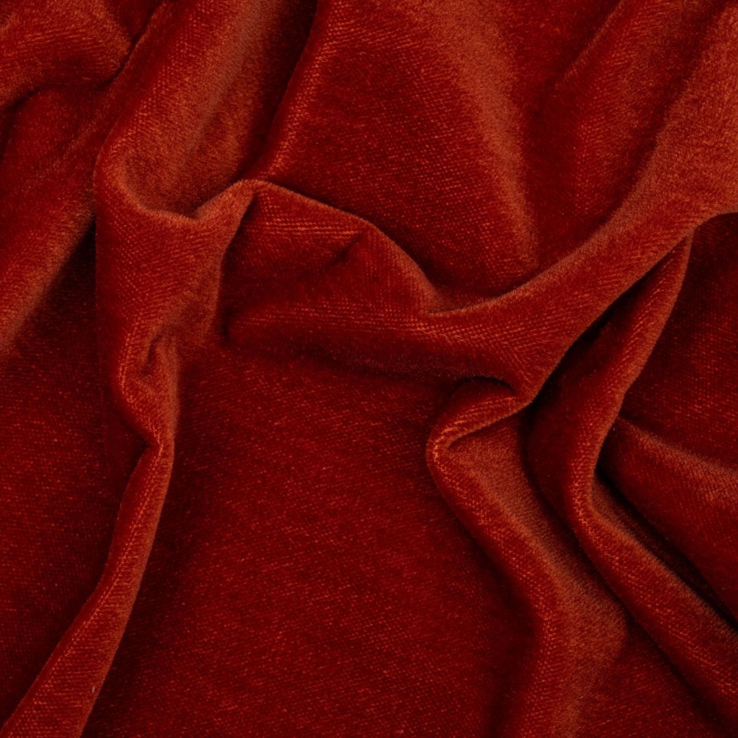 Close-up of red fabric with a textured fold