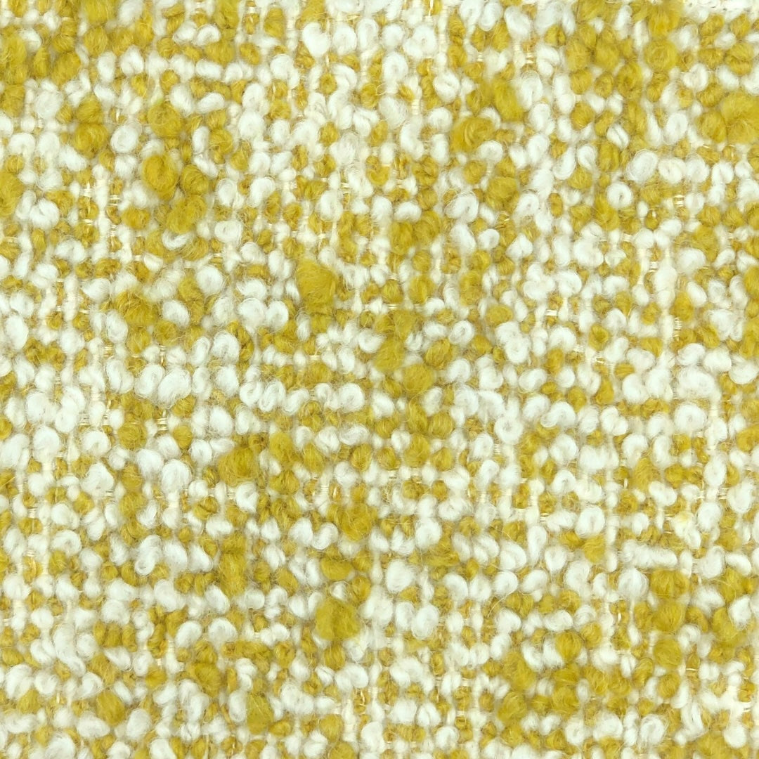 Fuzzy boucle pilled weave upholstery with yellow and off-white threads.