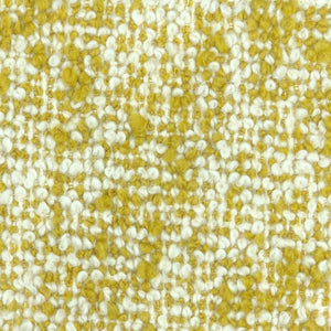 Fuzzy boucle pilled weave upholstery with yellow and off-white threads.