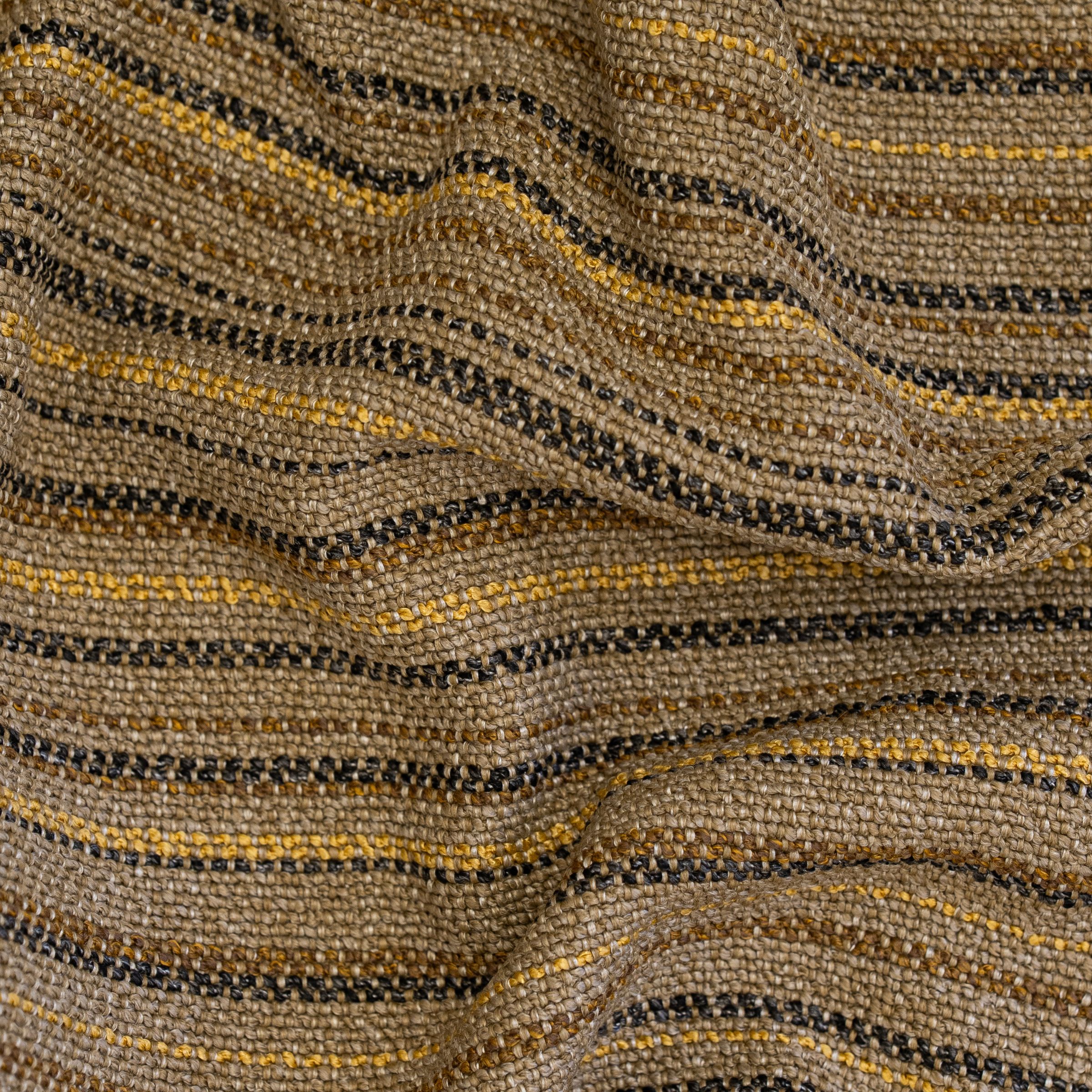 Close-up of textured fabric with wavy pattern in brown, black, and gold.
