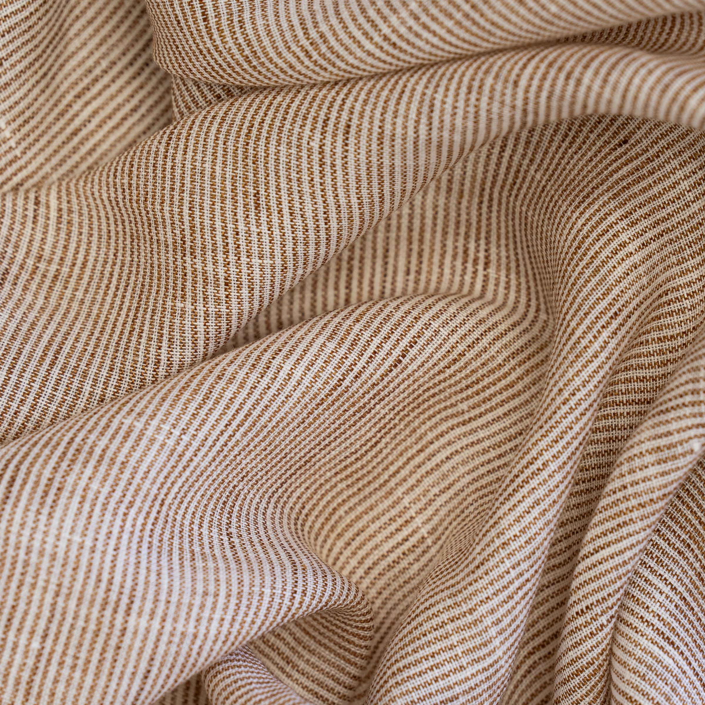 Close-up of beige striped fabric with subtle wavy texture