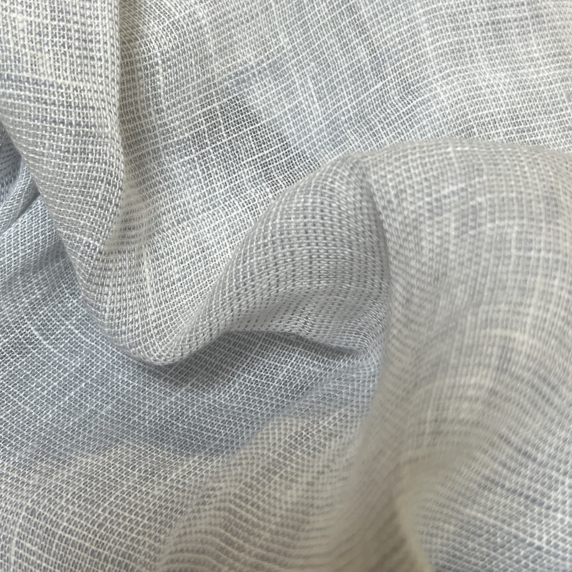 Close-up of blue-gray mesh fabric, with wavy folds