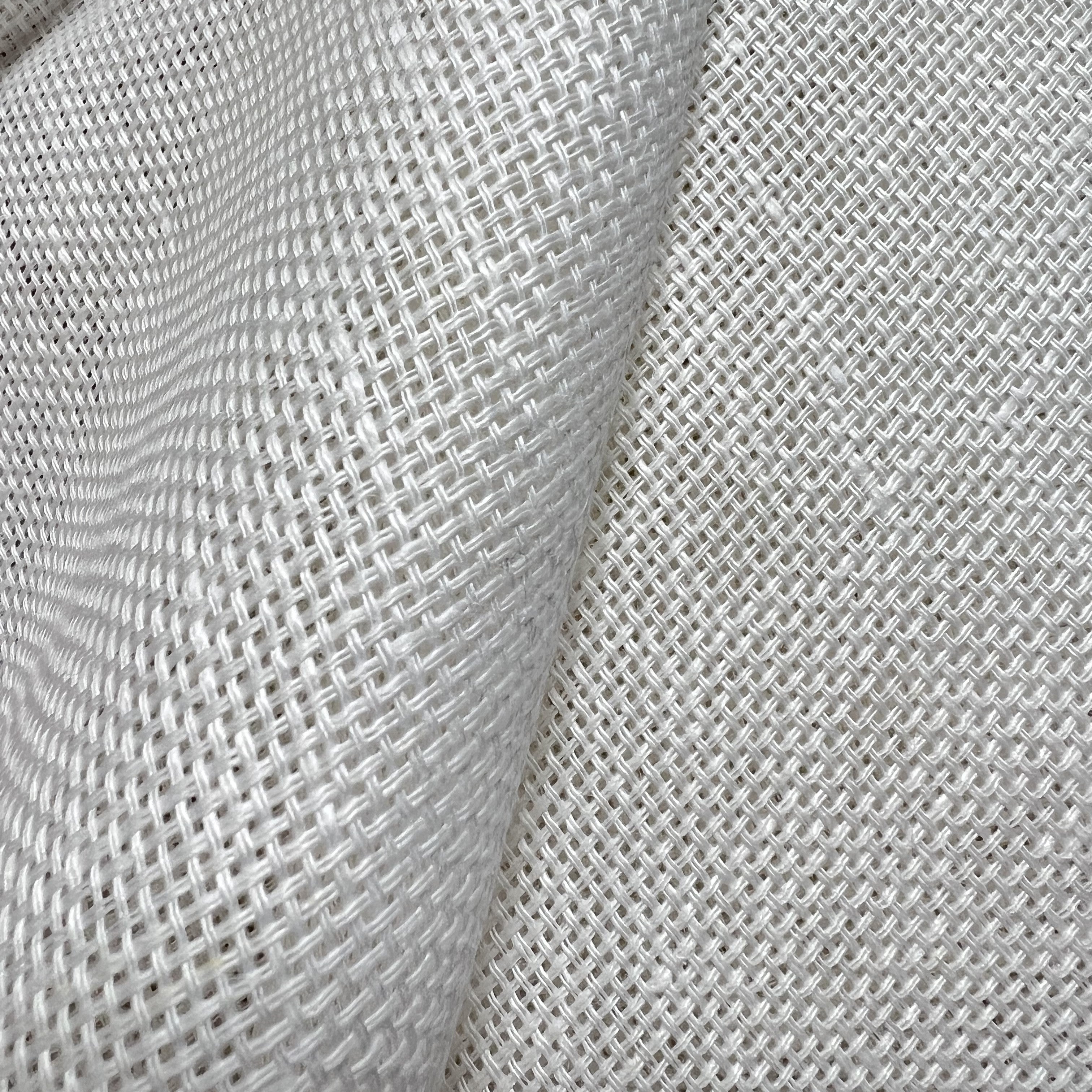 Pure white linen fabric with a artificial weave and large fold