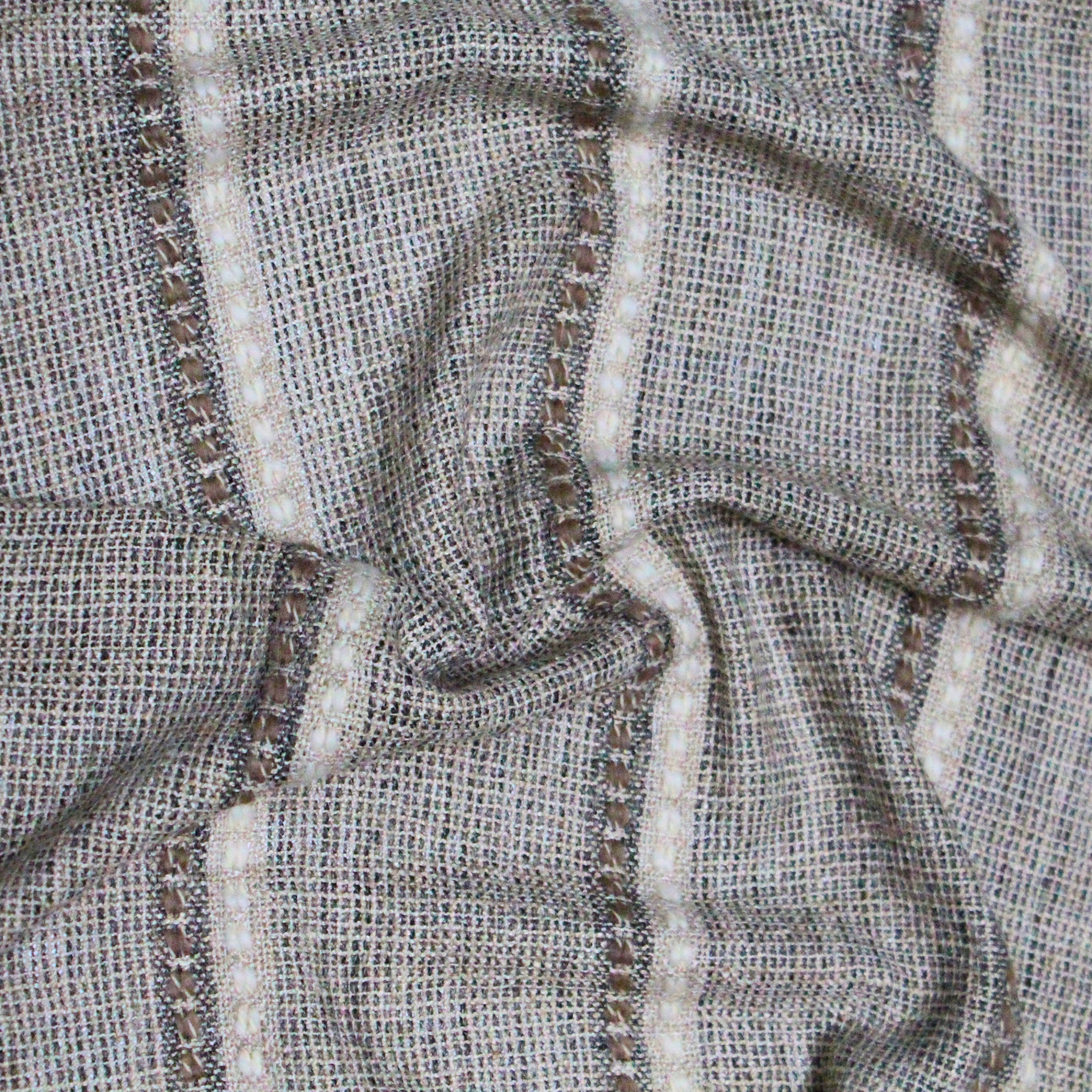 Textured thin brown and off-white stripes on a textured beige background with scrunched folds