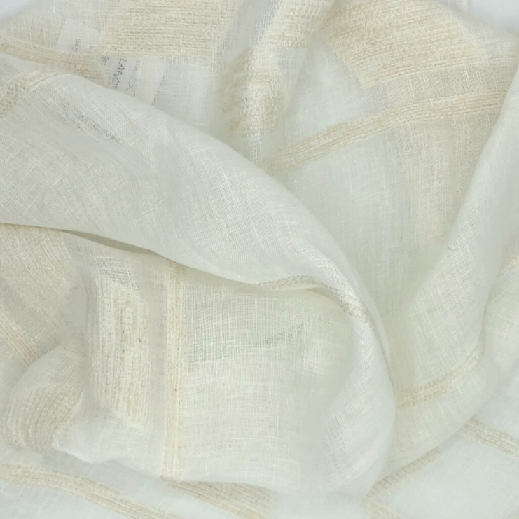 Lancy is a sheer white fabric with a natural colored raised geometric stripe pattern. 