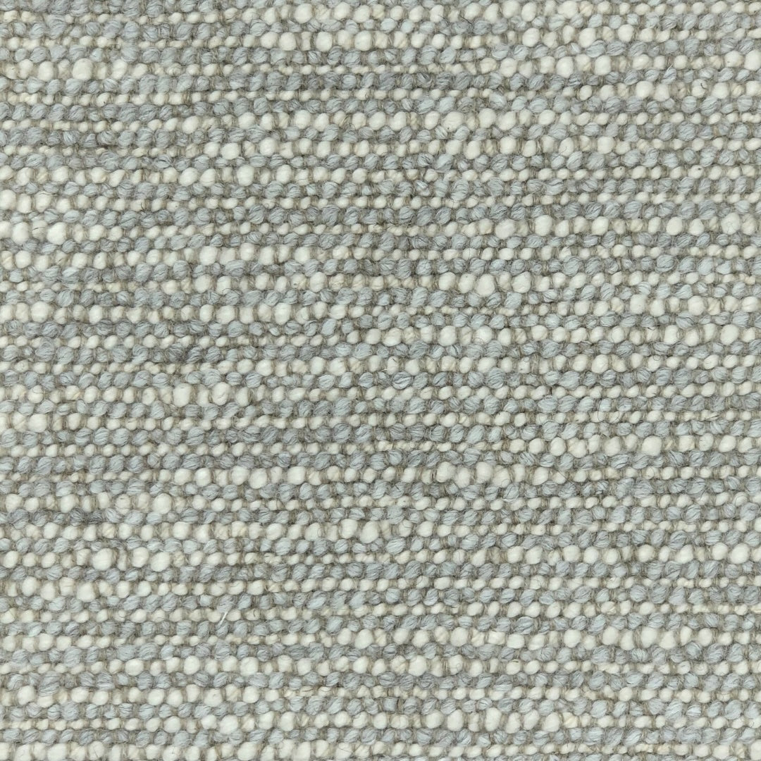 Lecce a textured upholstery in gray and blue with a pronounced looped weave, giving it a chuncky appearance. 