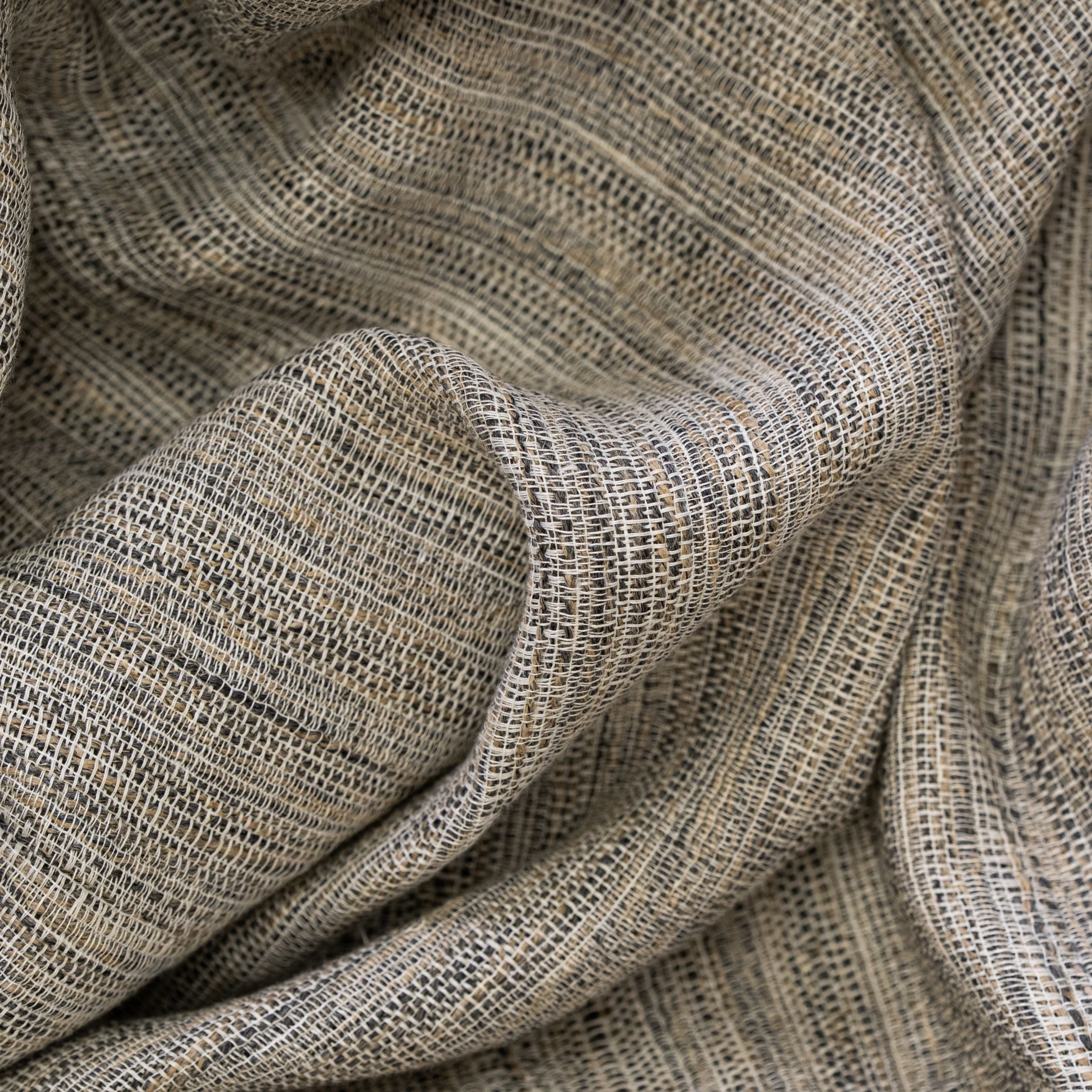 Textured brown, gray and white fabric pattern with wavy fold