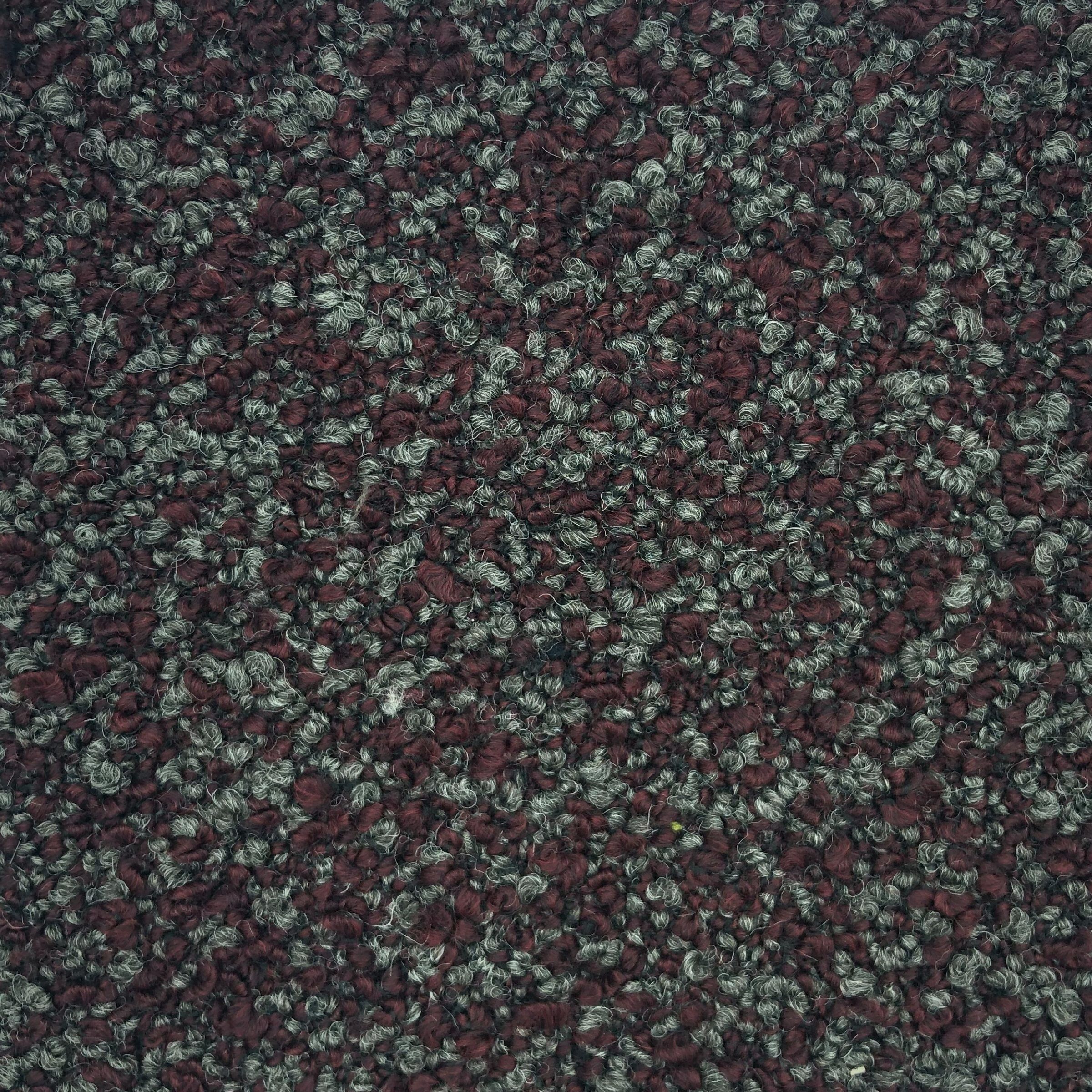 Maira - Pinot is a highly textured, pebbled surface creating a contrast of soft fuzzy maroon and charcoal fibers. 