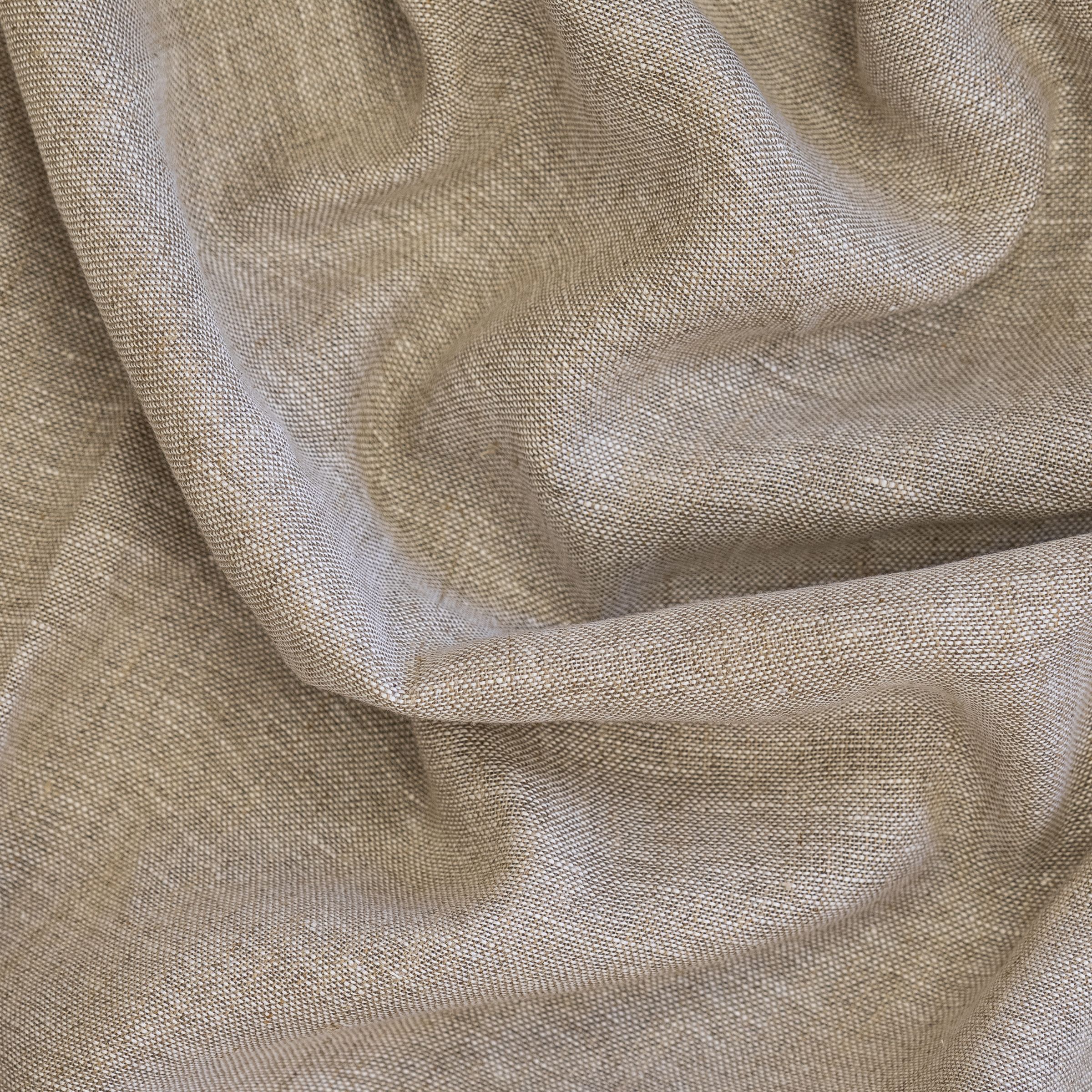 Close-up of beige textured fabric with a horizontal wavy fold