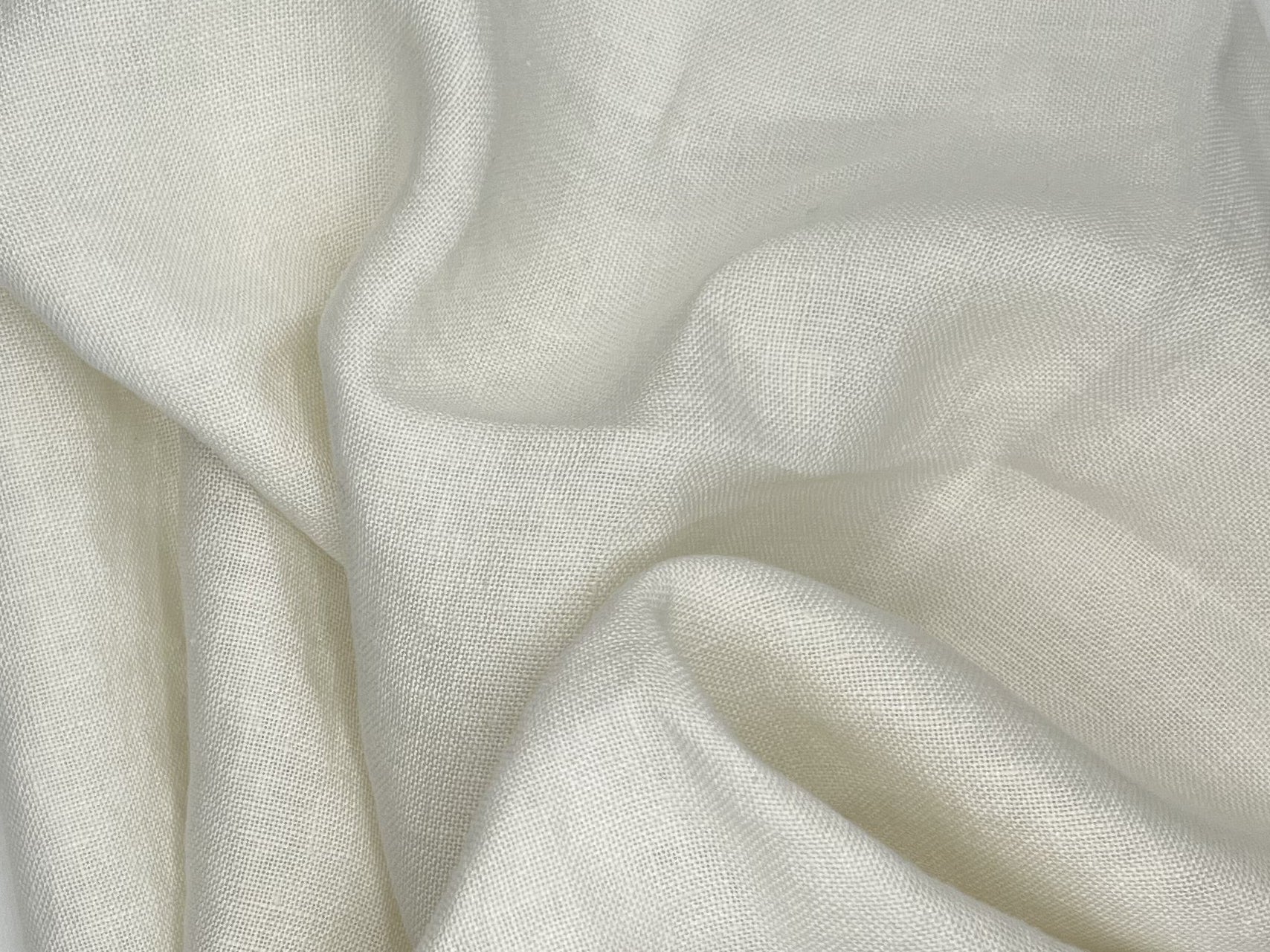 White fabric sample with large wavy folds