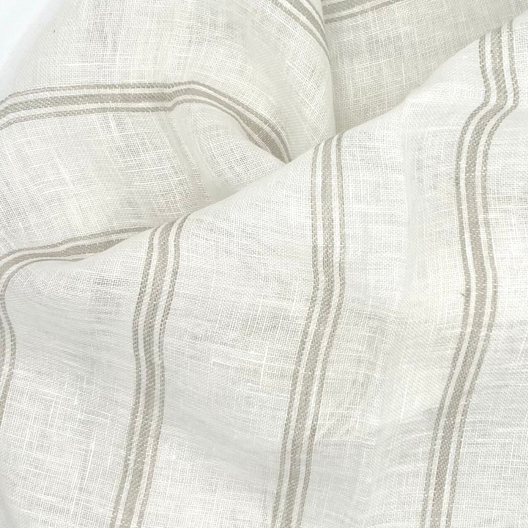Mykonos fabric is an off-white linen fabric, with a thin natural linen colored stripe with large folds