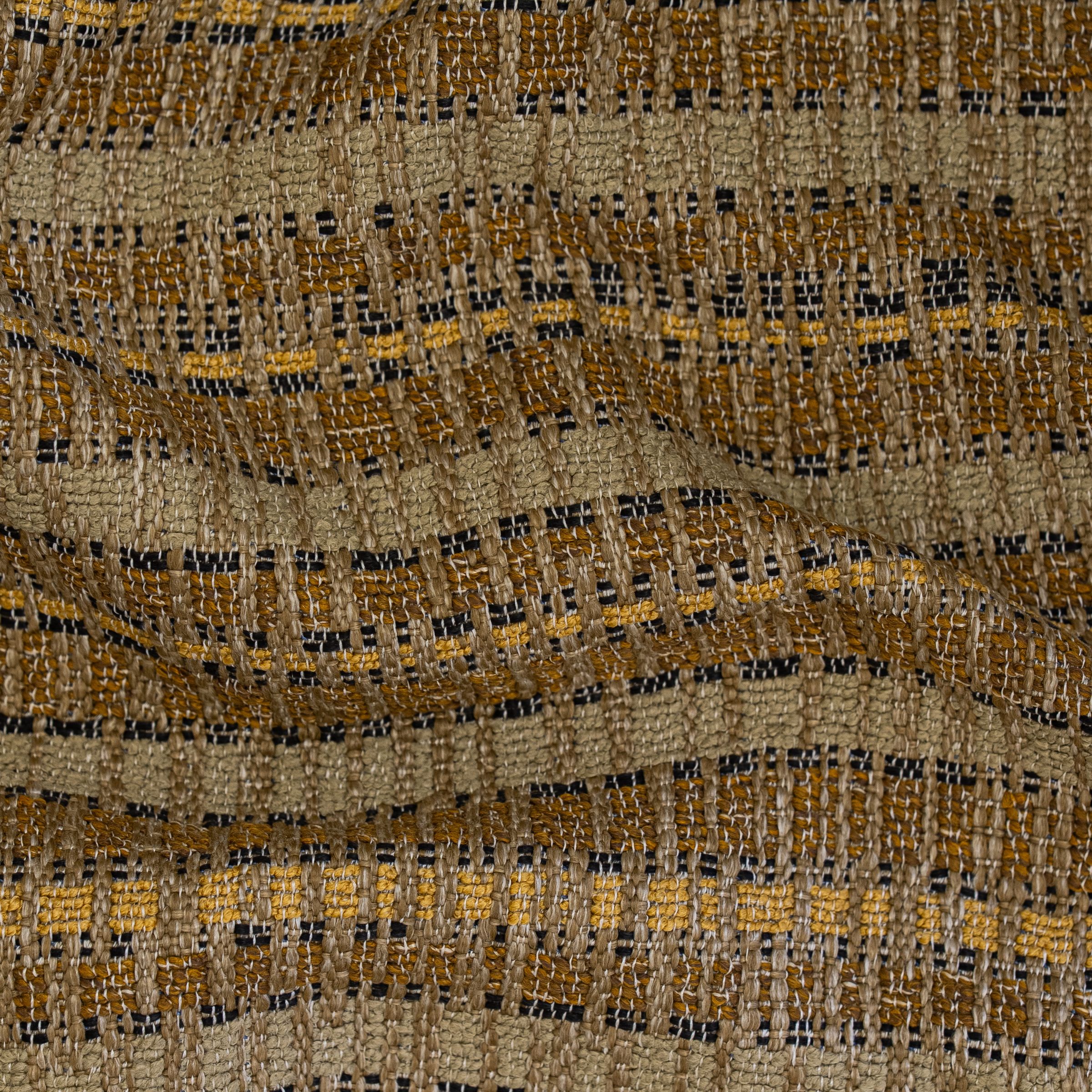 Textured beige upholstery patterned with brown, yellow and black tones with subtle folds