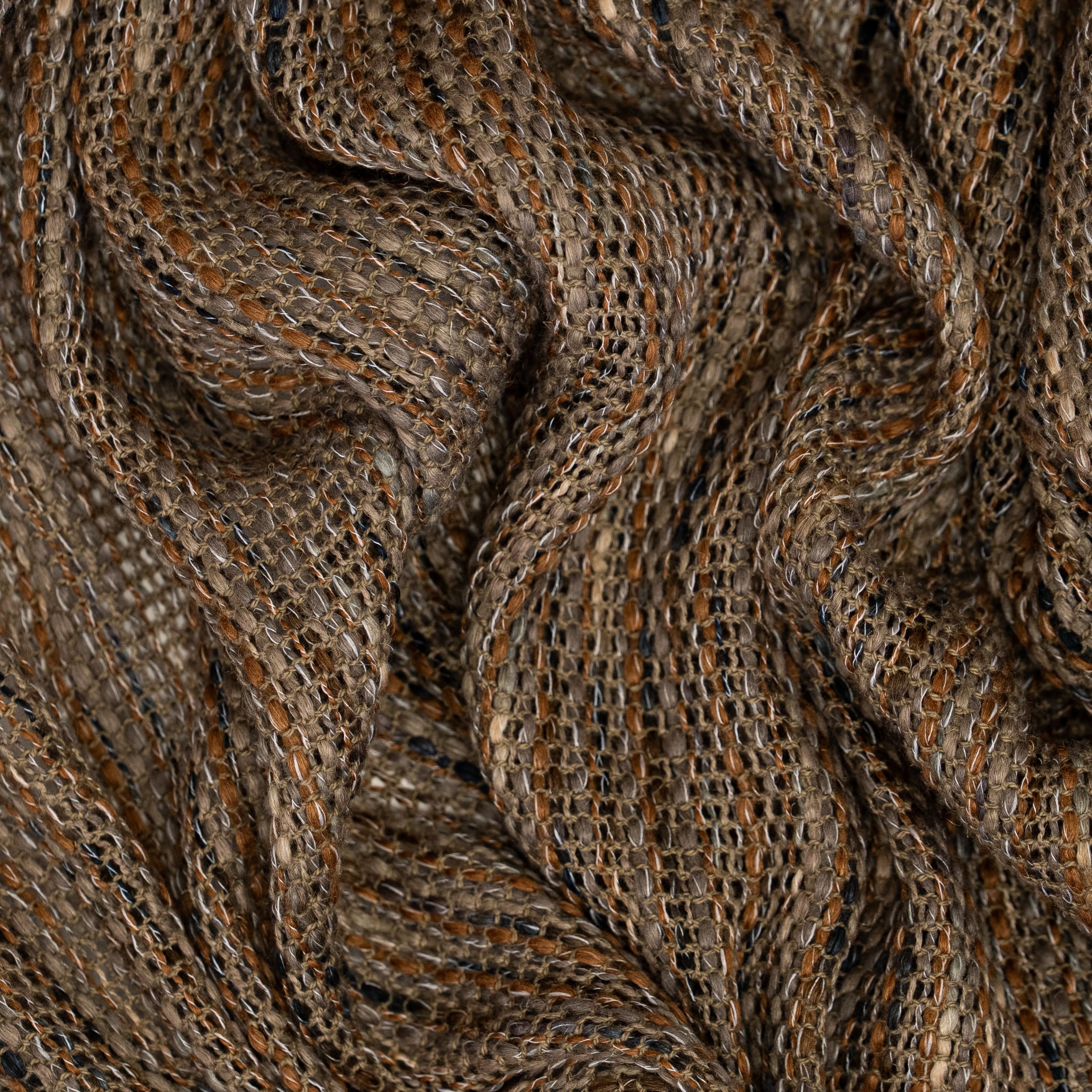 Loose weave fabric with intersection browns, grays, beige and black threads and large wavy folds.