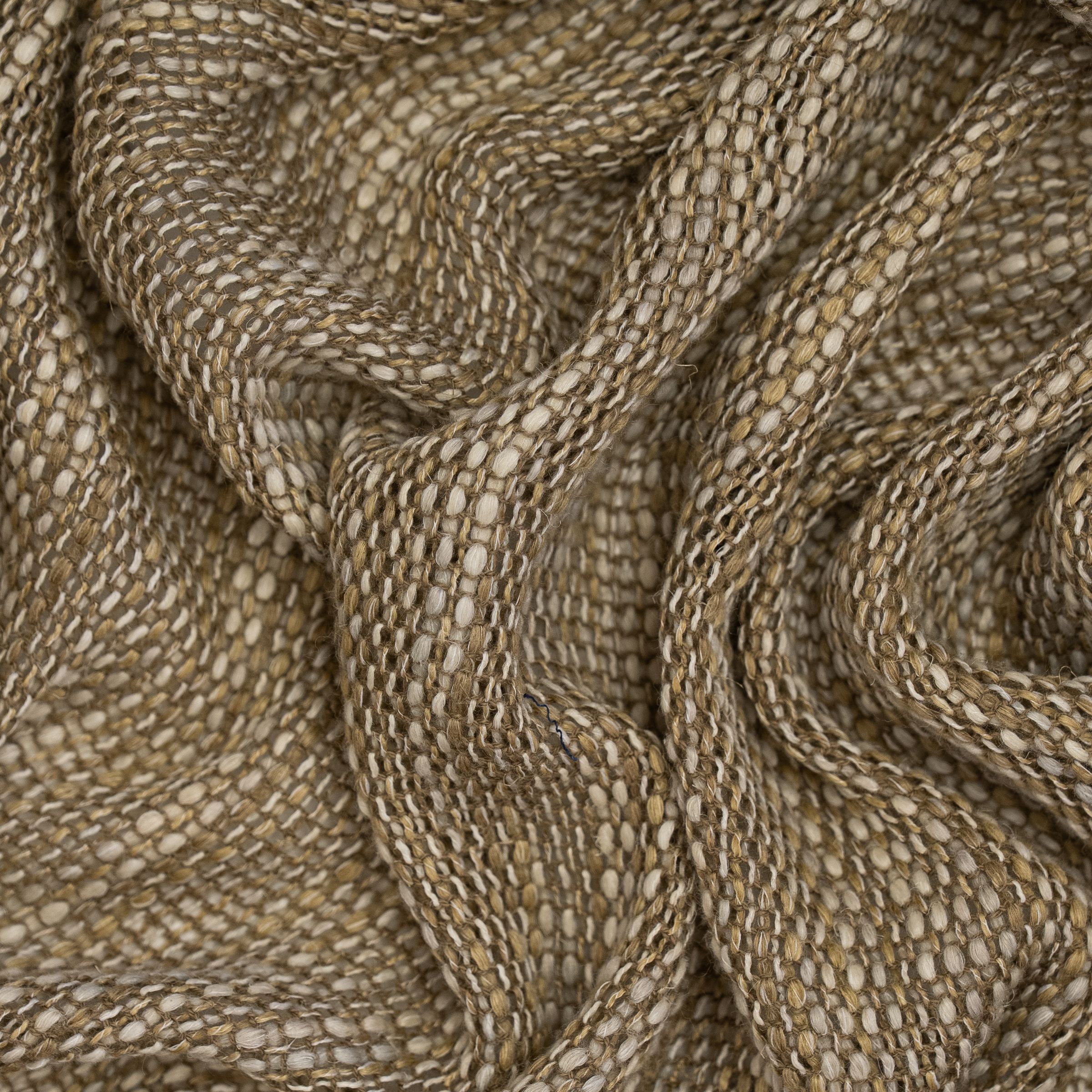 Loose weave beige fabric with white threads and large wavy folds
