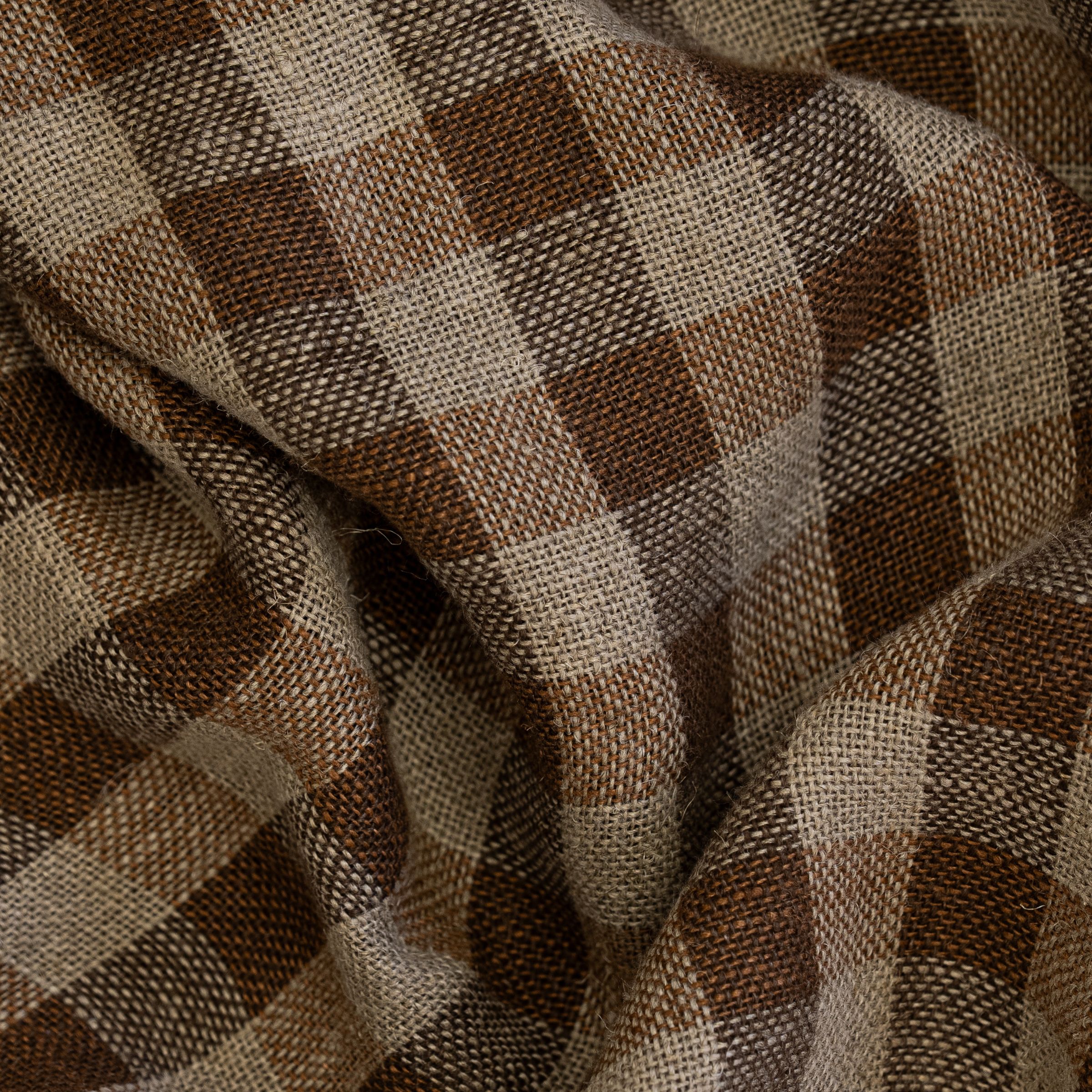 Brown and beige checkered pattern fabric with large folds