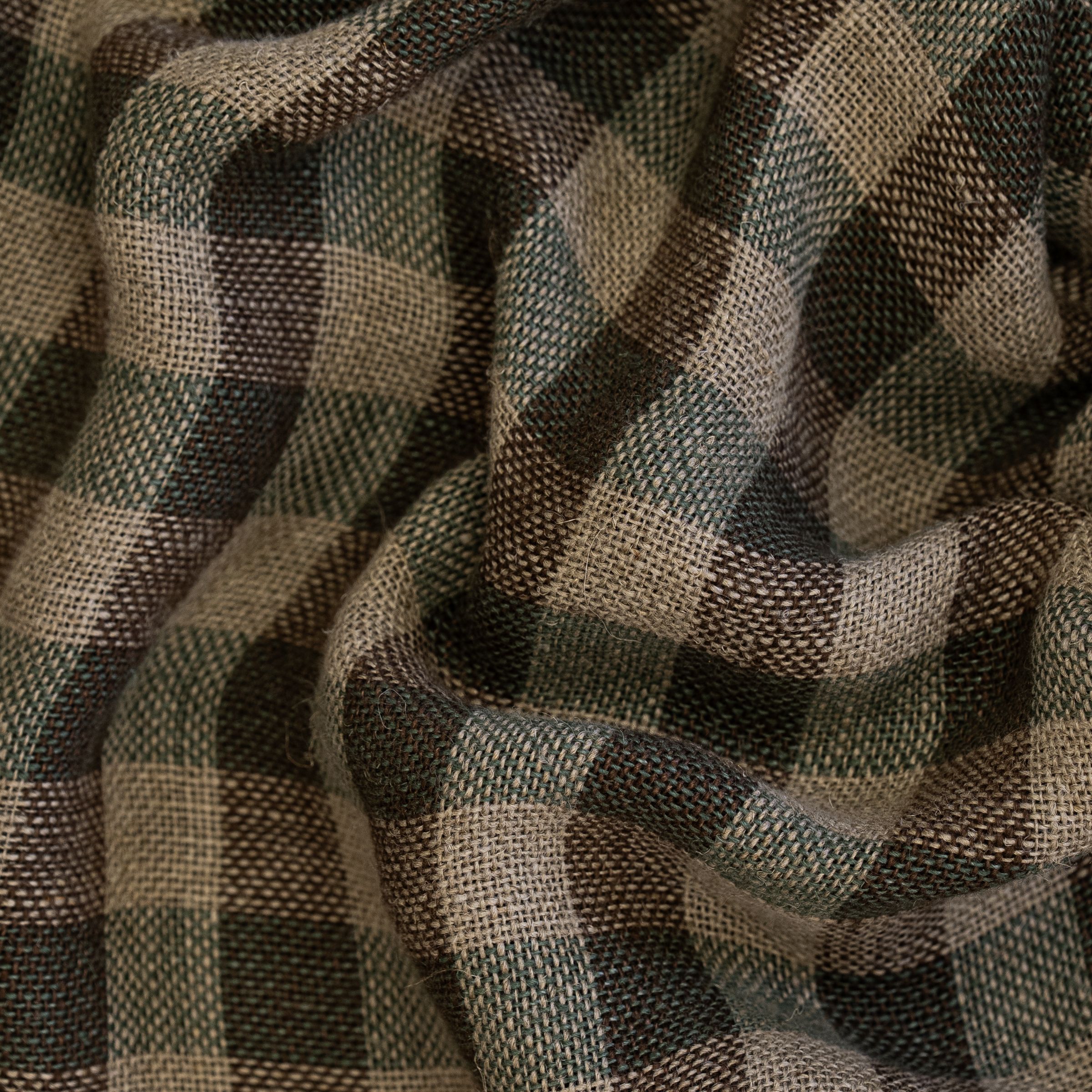 Checkered pattern fabric with brown and green colors with large wavy folds