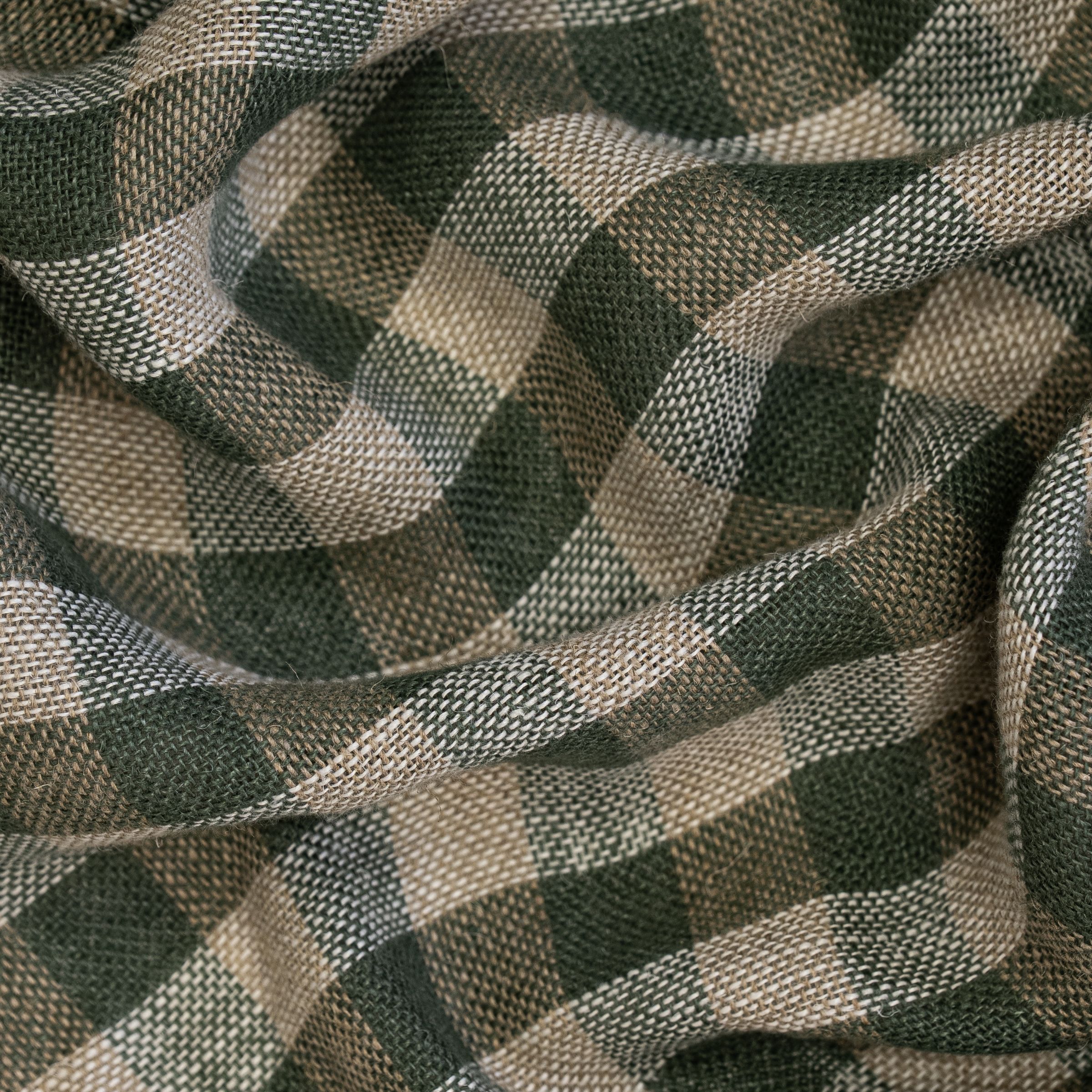 Green and white checkered fabric pattern with large wavy folds