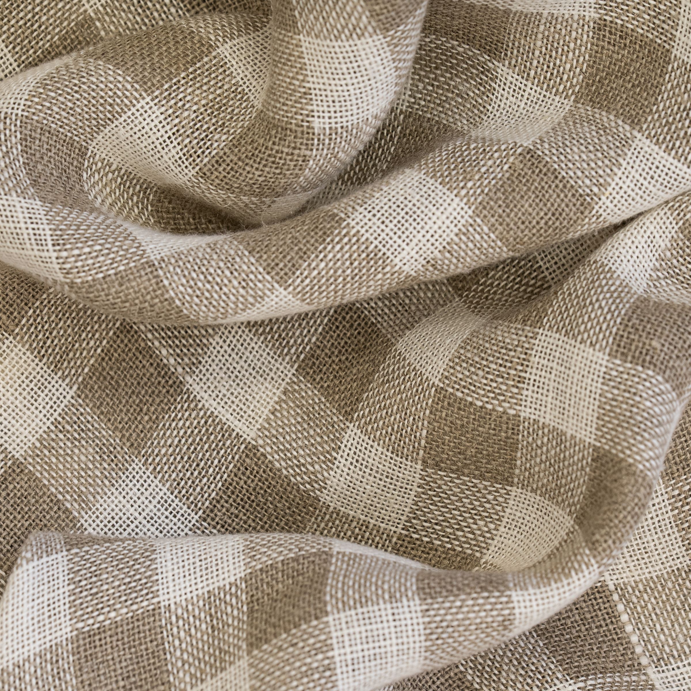 Checkered pattern with white and beige squares along with wavy folds
