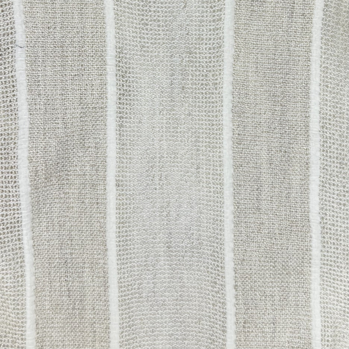 Close-up of light gray fabric showing a loose plain weave and prominent, medium-width textured white vertical stripes.