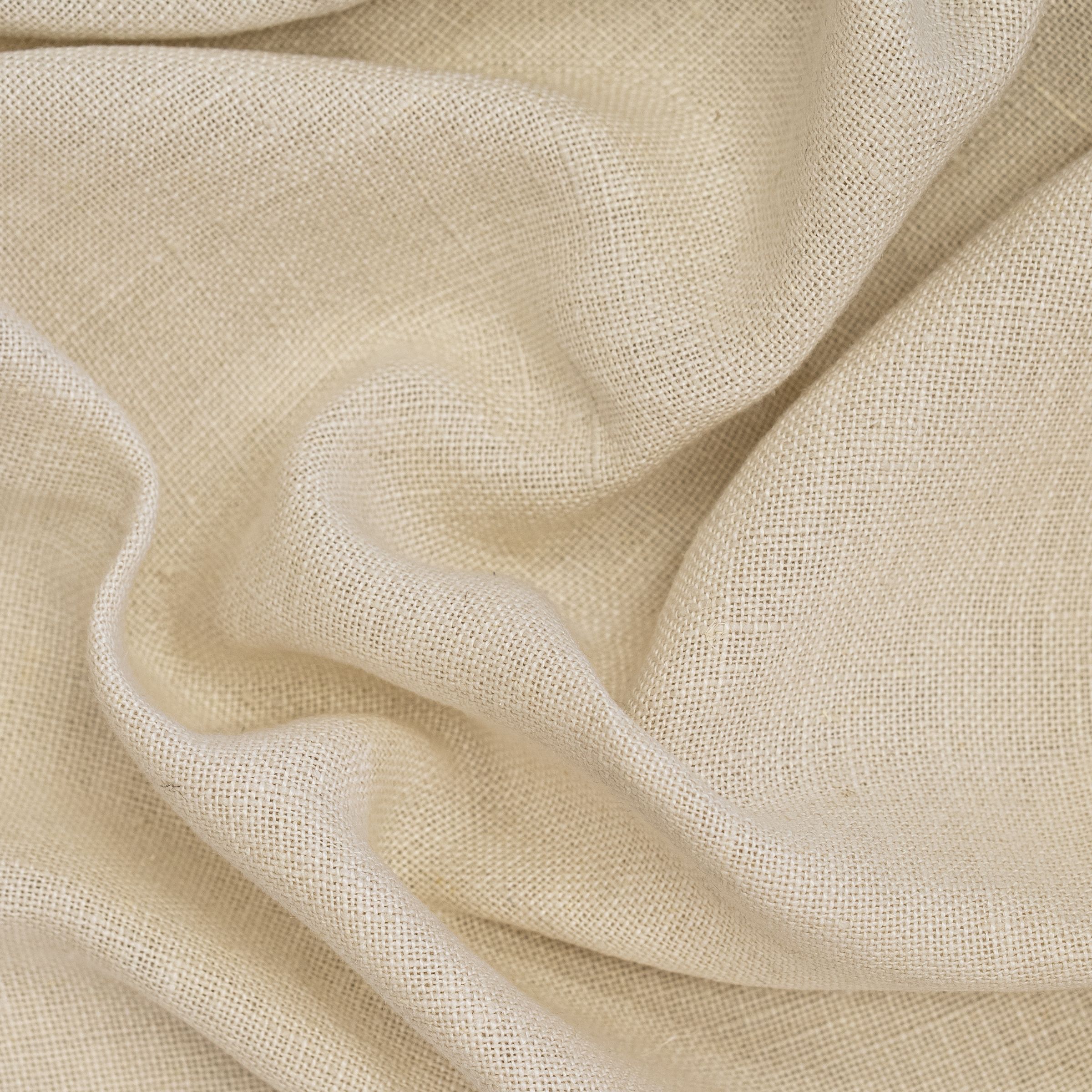 Close-up of beige fabric with soft wavy folds