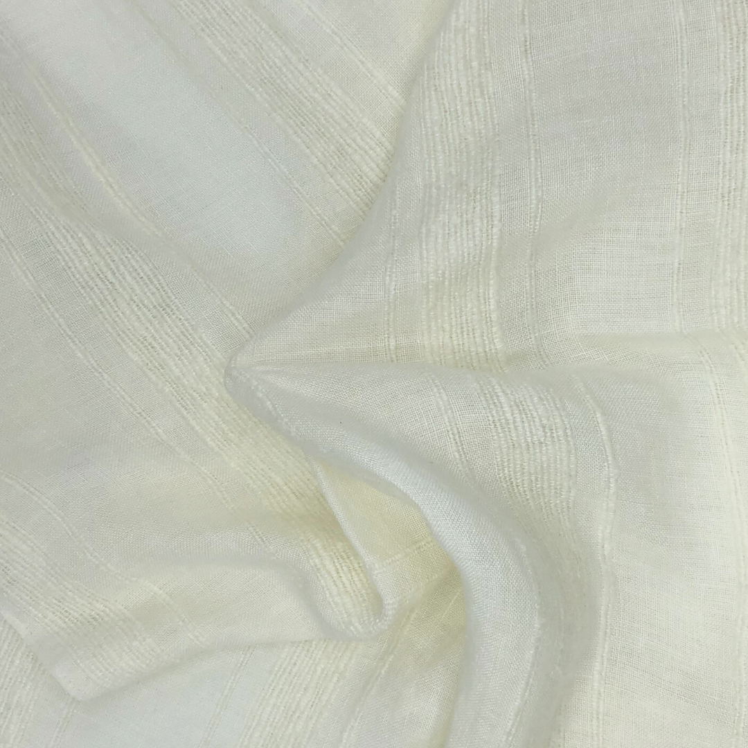 Close-up of textured stripes on white fabric with twisted folds