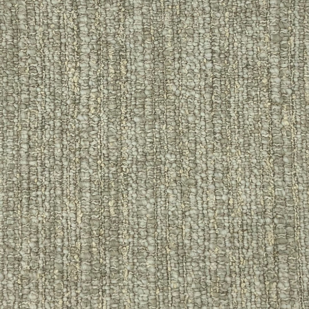 Light beige fabric with a dense, nubby weave characterized by small loops and knots.