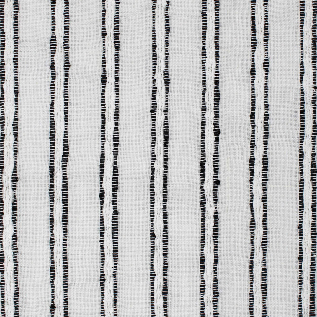 Close-up of white fabric showing a plain weave and prominent, slightly textured black vertical stripes.
