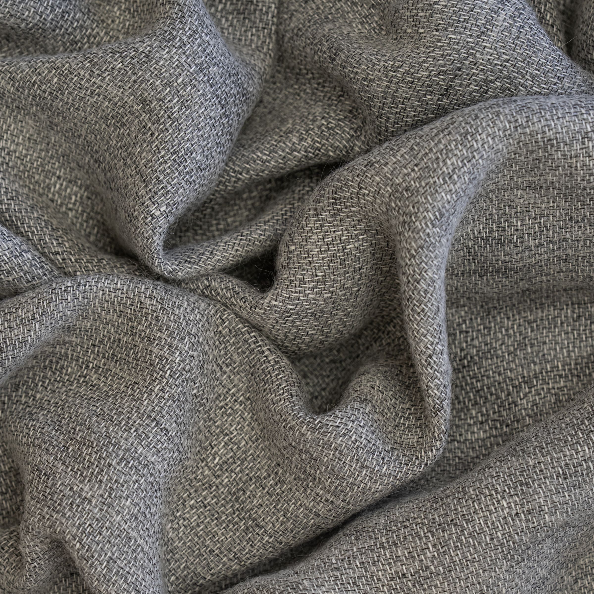 Close-up of textured gray fabric and large wavy folds
