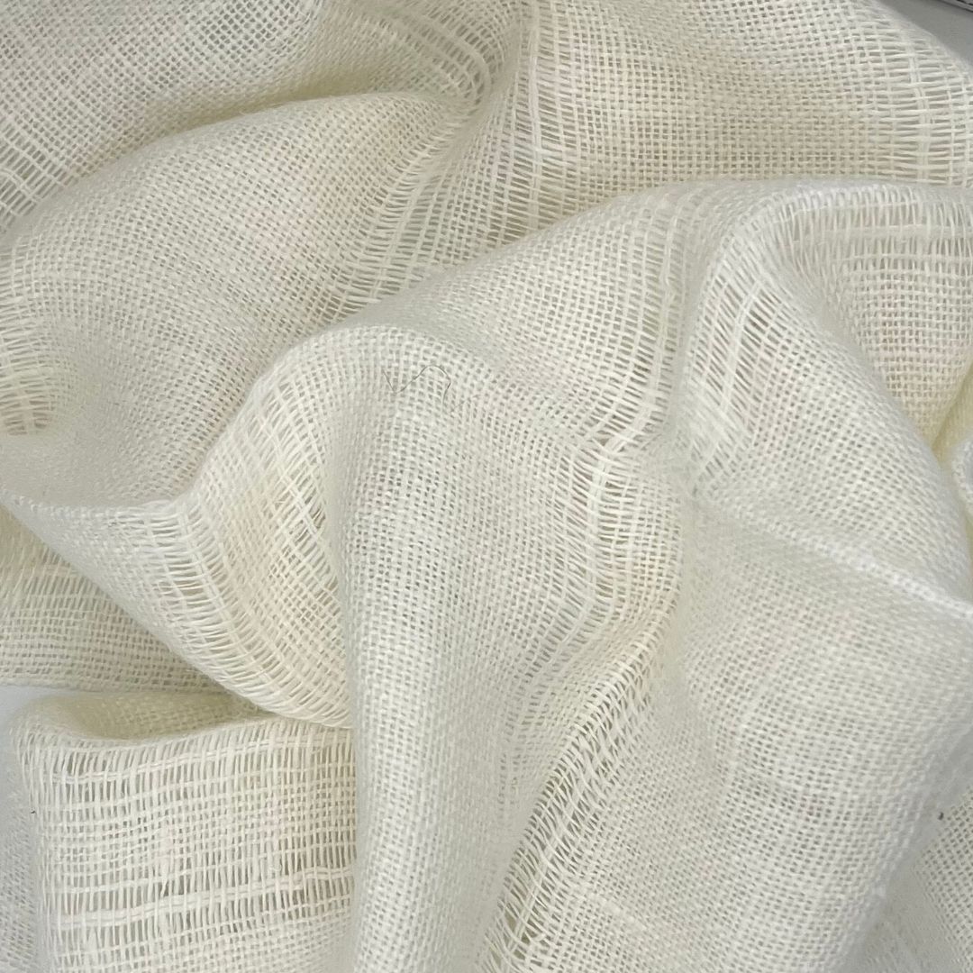 Close-up of white mesh fabric with wavy folds