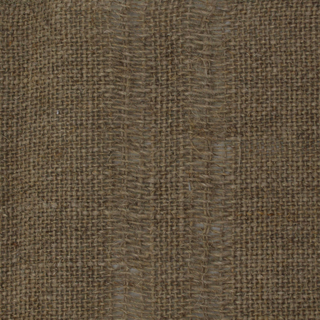 Close-up of draped brown sheer fabric highlighting the loose weave structure and the way light filters through the folds.