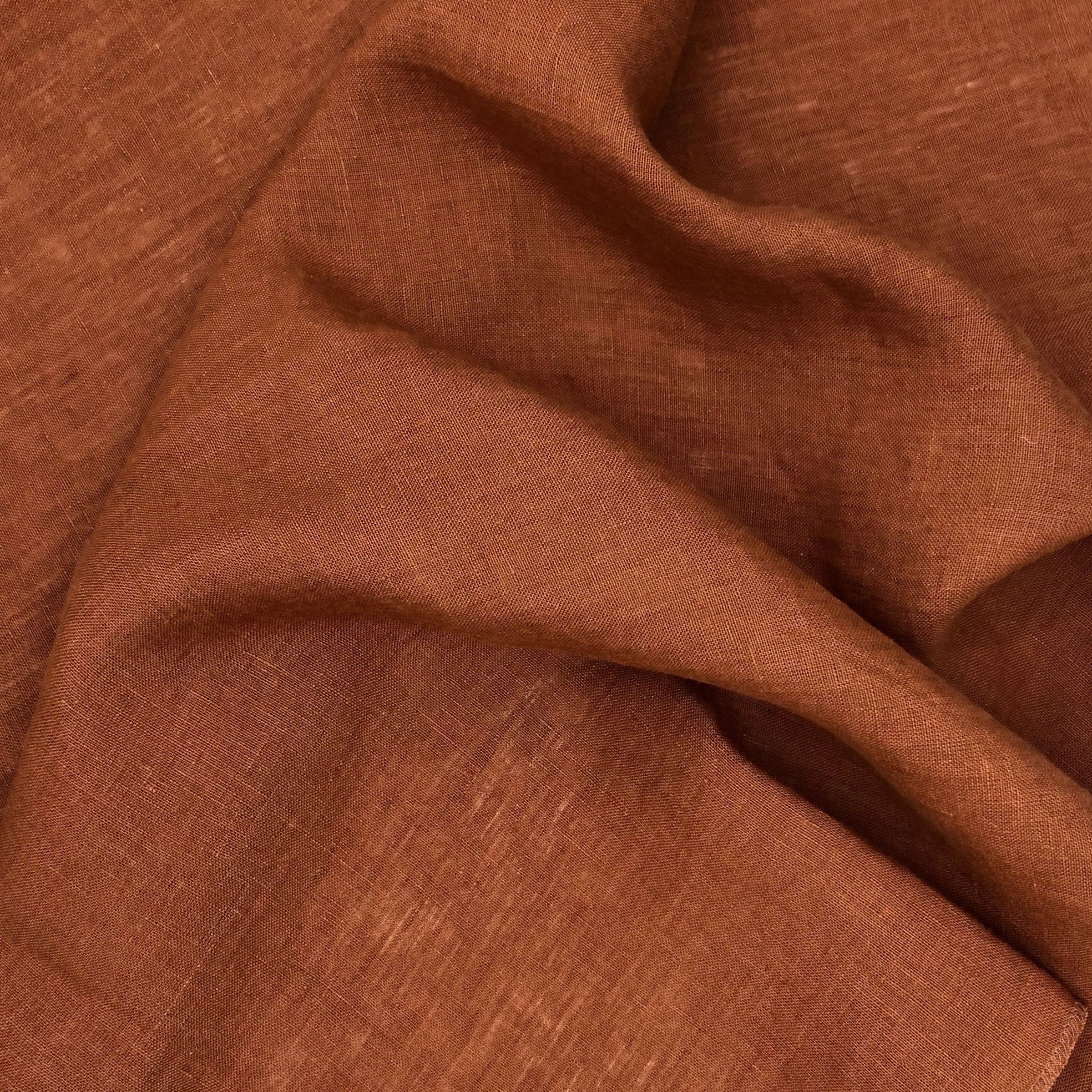 Rusted orange fabric with wavy folds