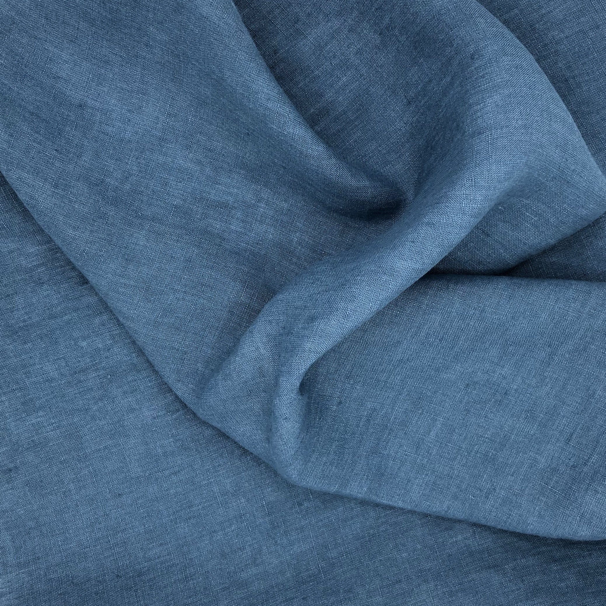 Denim blue smooth fabric with wavy folds