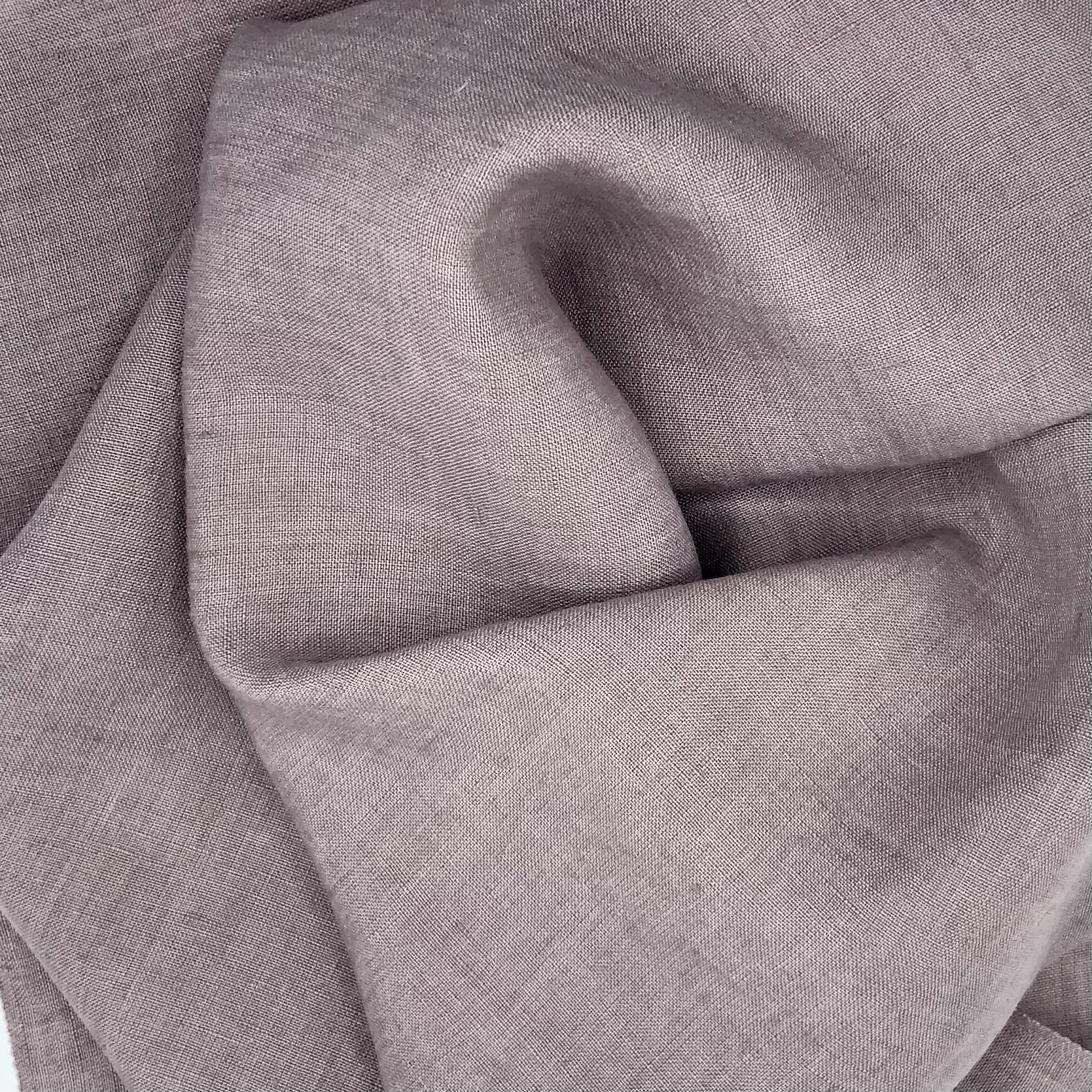 Close-up of a purple-gray fabric with a subtle wavy fold
