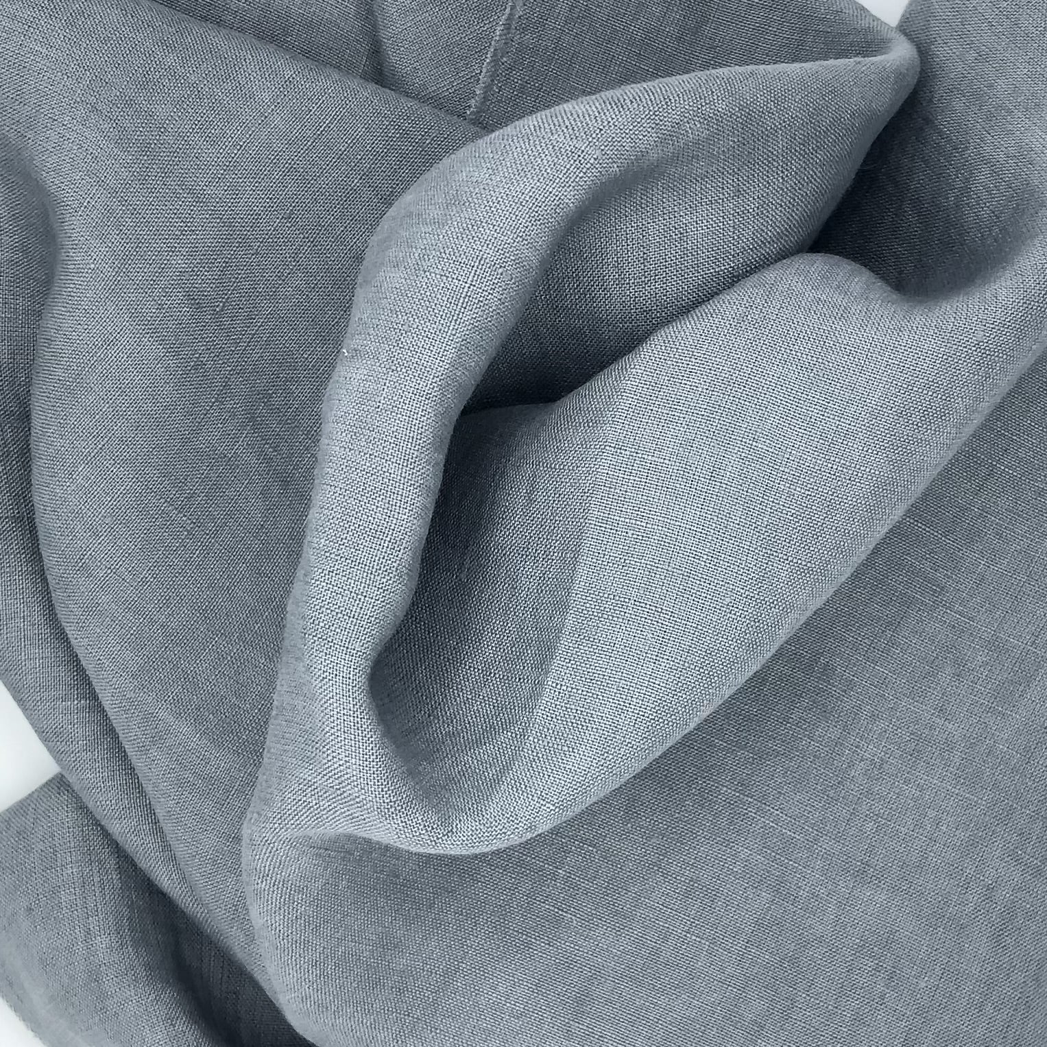 Close-up of light blue-gray fabric with large folds