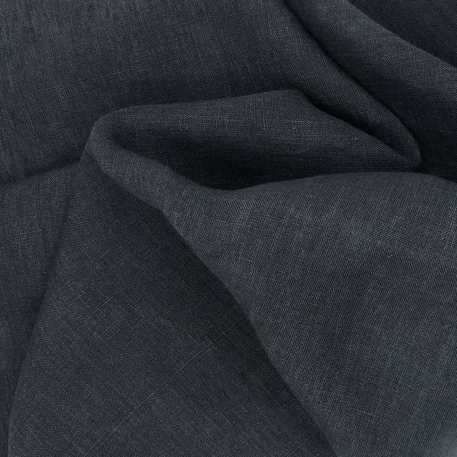 Close-up charcoal gray matte fabric with large wavy folds